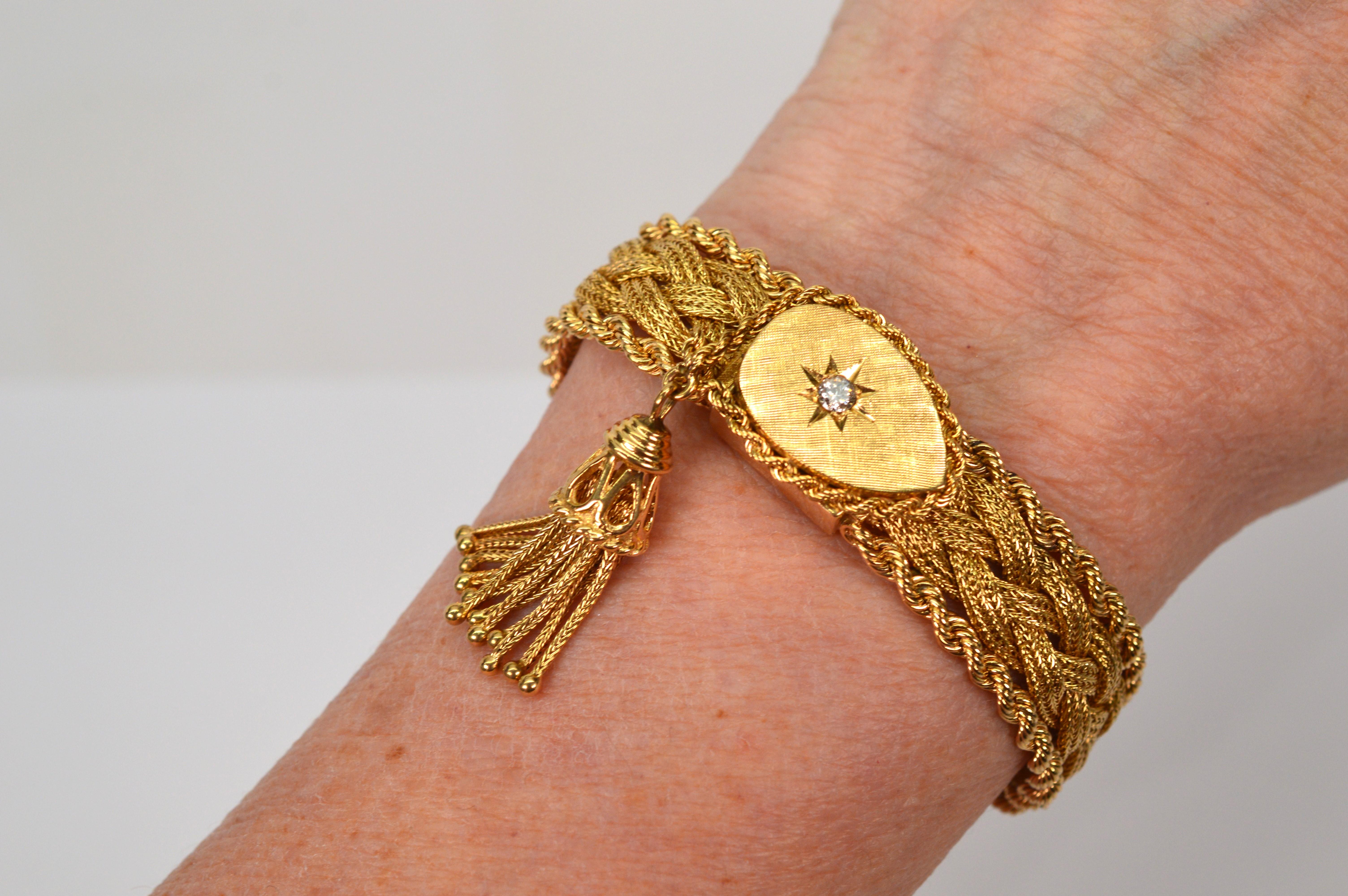 With all the best features of the madly popular retro period, one can truly appreciate the elegant design of this mid-century 
diamond accented woven 14 karat yellow gold bracelet with unique mystery watch feature. Complementing twists of gold rope