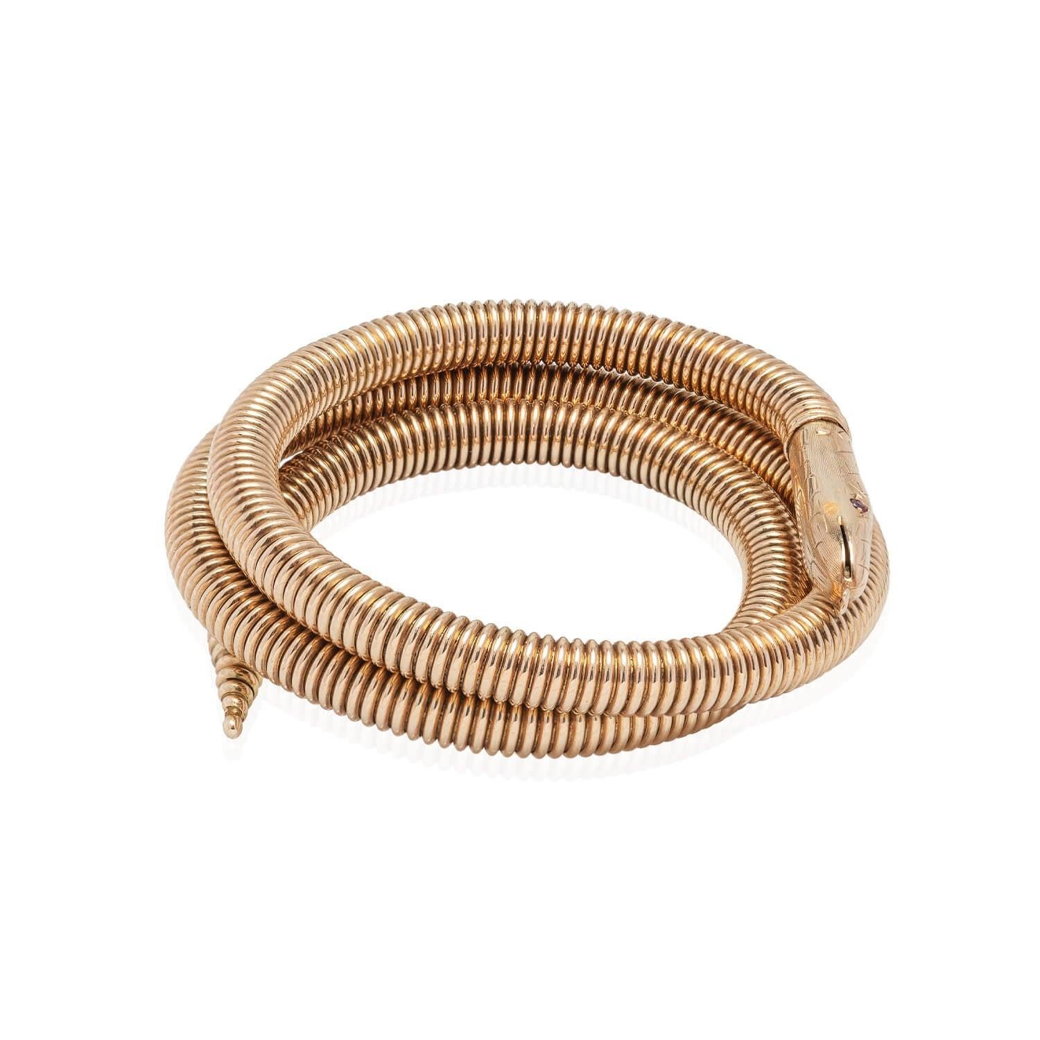 A fabulous snake bracelet from the Retro (ca1940s) era! Crafted in 14kt yellow gold, this wonderful piece is in the shape of a 3-dimensional snake. A tightly coiled snake chain gives a wonderful texture to the design, tapering to a pointed tail. The