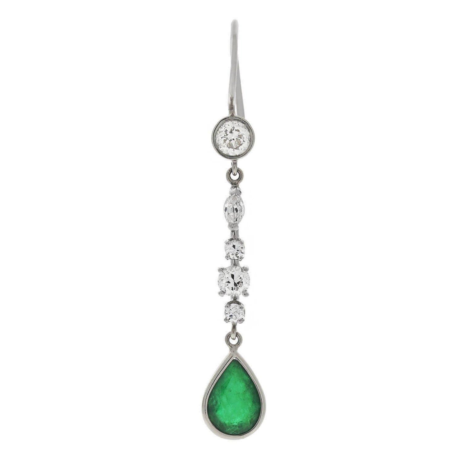 A stunning pair of dangling emerald and diamond earrings from the Retro (ca1940s) era! Crafted in 14kt white gold, these elegant earrings display a simple, yet beautiful drop design. Each earring begins with a gold earring wire attached to a single