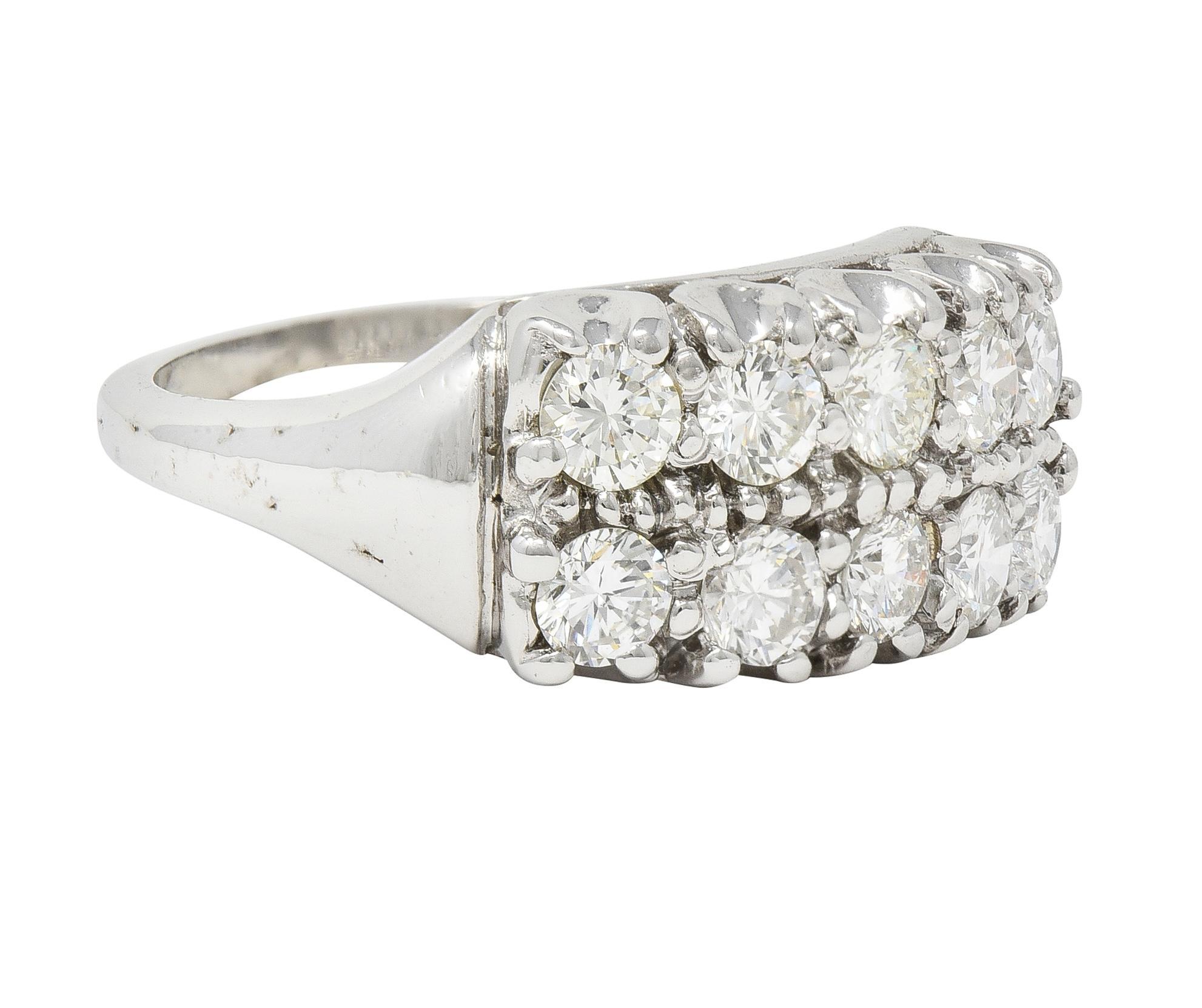 Band ring is designed as two east to west rows of round brilliant cut diamonds
Weighing collectively approximately 1.50 carats with G/H color and VS clarity
Set with fishtail motif prongs
Stamped for 14 karat gold
Circa: 1940s
Ring Size: 5 3/4 &