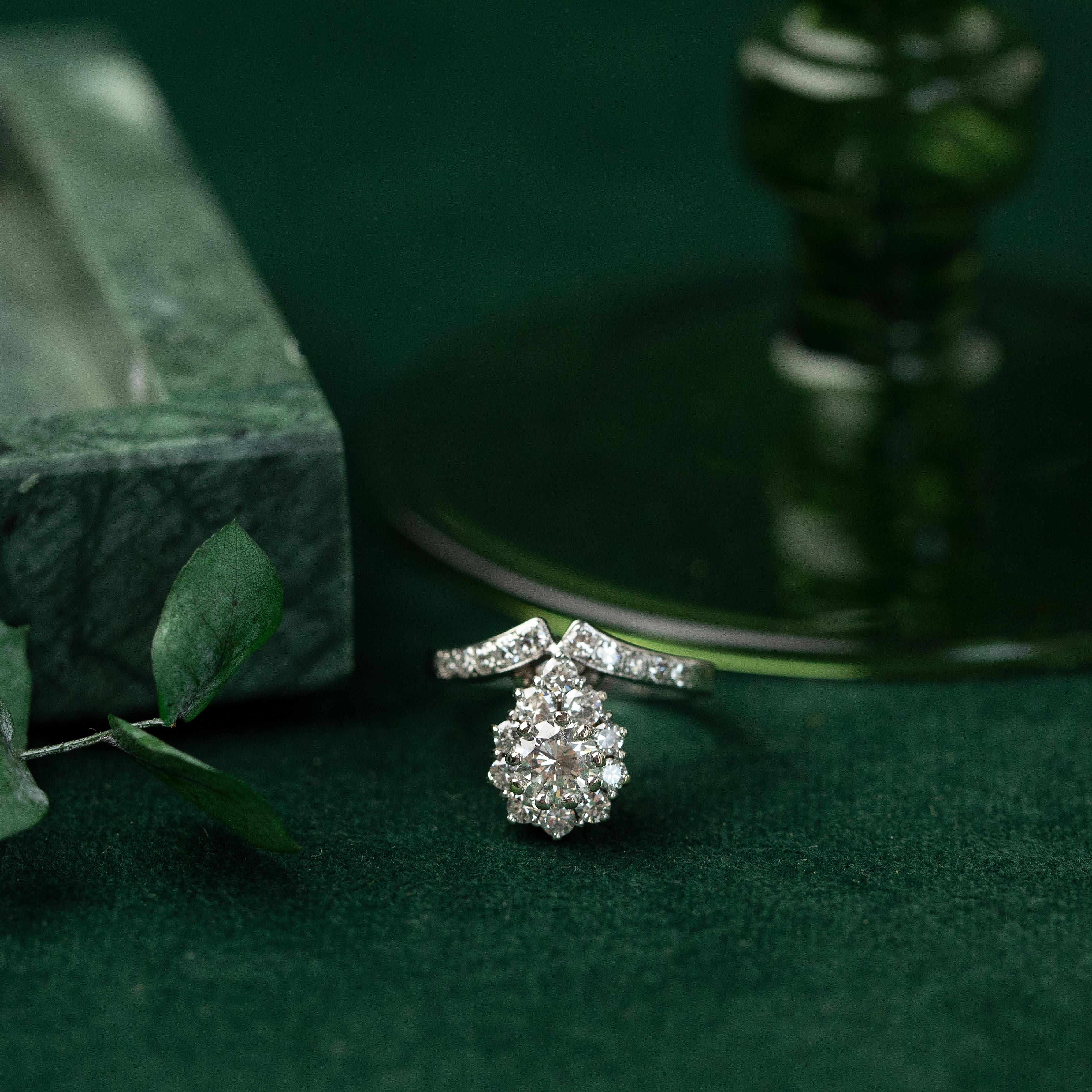 A unique ring design for anyone looking for something different than the typical diamond ring offerings. Similar to “tiara” rings from the previous eras, this ring features a 0.88 carat round brilliant cut diamond surrounded by a halo of an