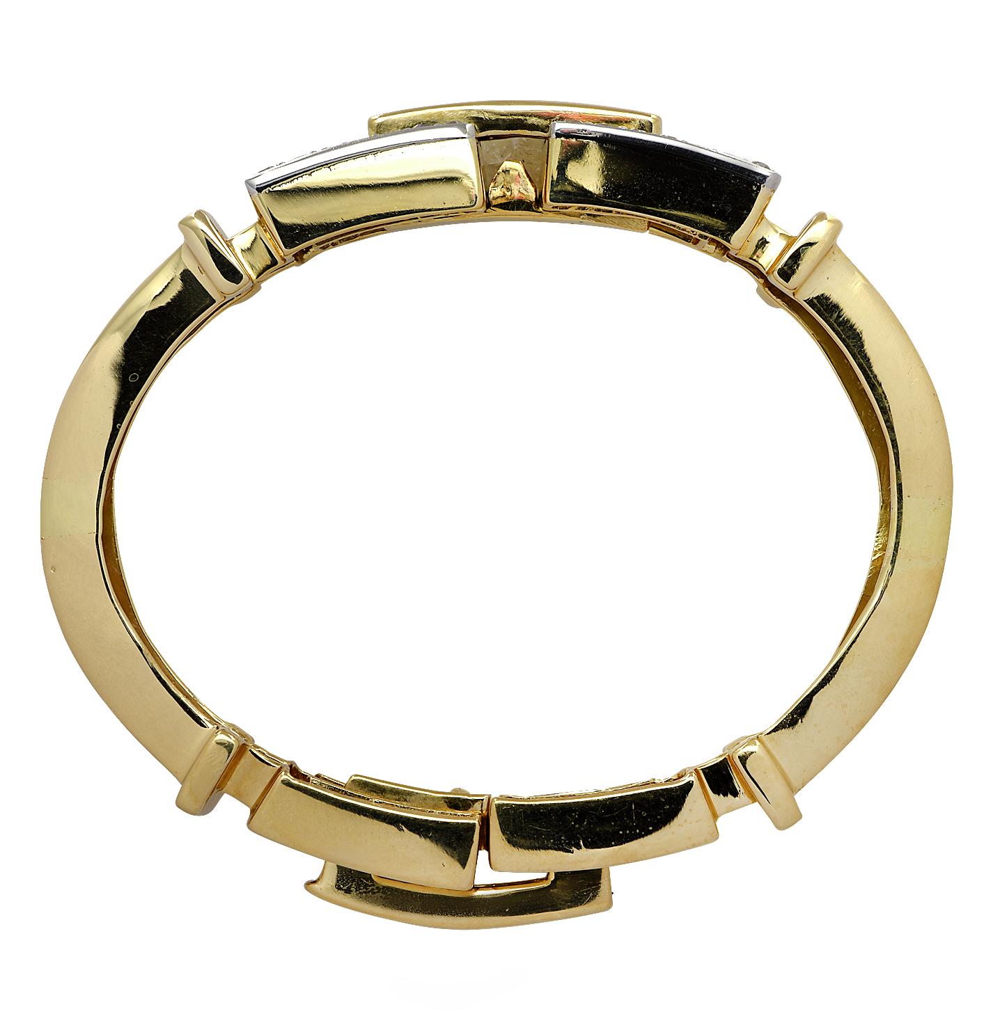 Striking Retro bangle bracelet circa 1950, crafted in 18 karat yellow gold, featuring 32 Old European Cut diamonds weighing approximately 1.60 carats total, G-H color, VS-SI clarity set in an 18 karat white gold plate. This stunning bracelet