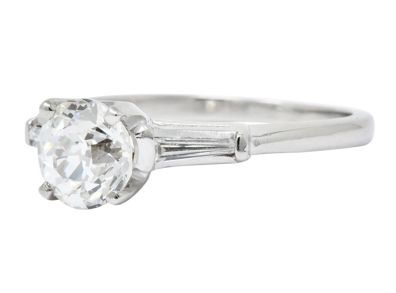 Cathedral style ring centering an old European cut diamond weighing 1.51 carats, J color and VS1 clarity

Flanked by two bar set, tapered baguette diamonds weighing approximately 0.15 carat total, I color and VS clarity

Stamped 10% Irid Platinum