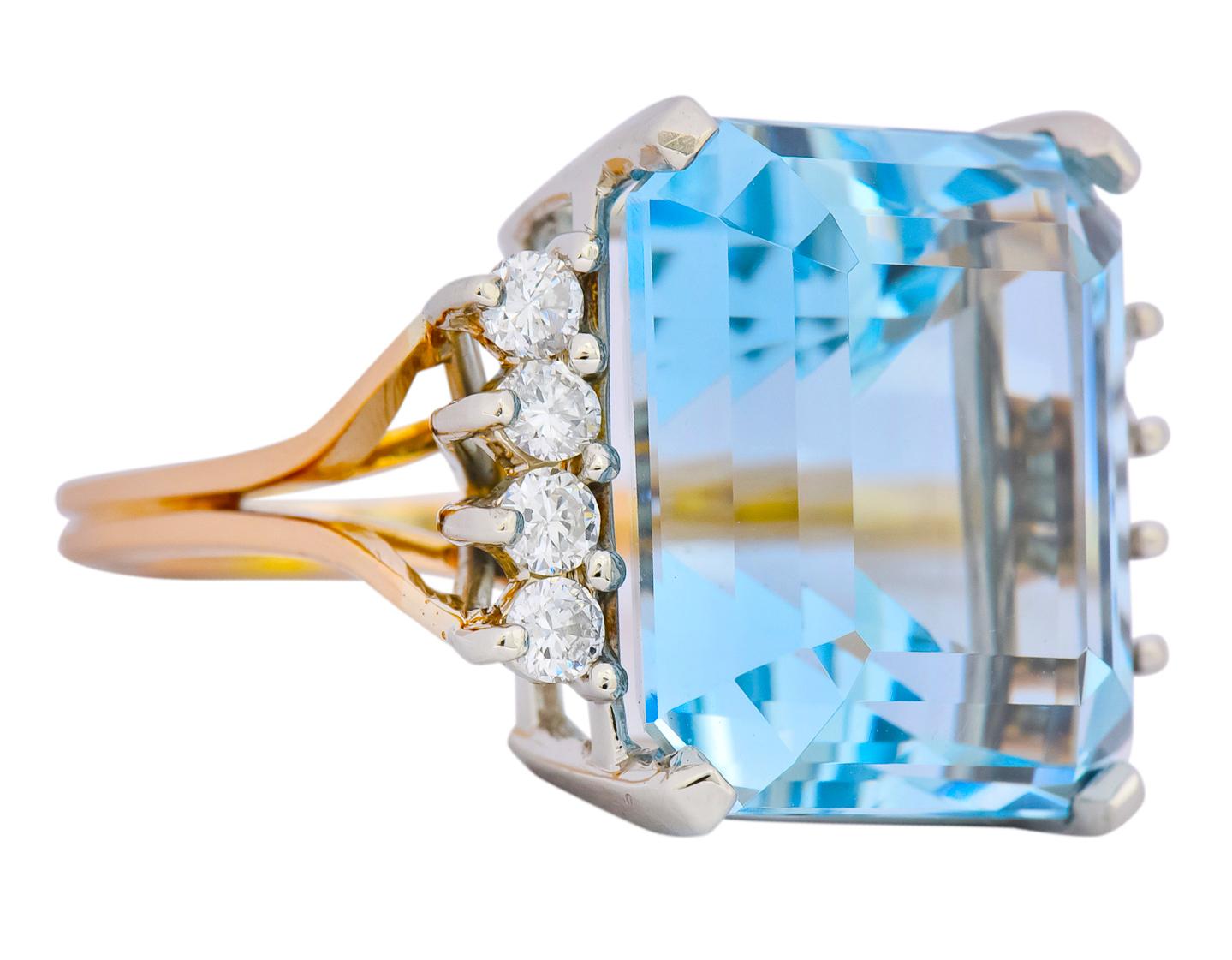 Centering an emerald cut aquamarine, basket set in white gold, weighing approximately 16.46 carats total, transparent and sky blue in color

Flanked by rows of round brilliant cut diamonds, prong set north to south, weighing approximately 0.32 carat