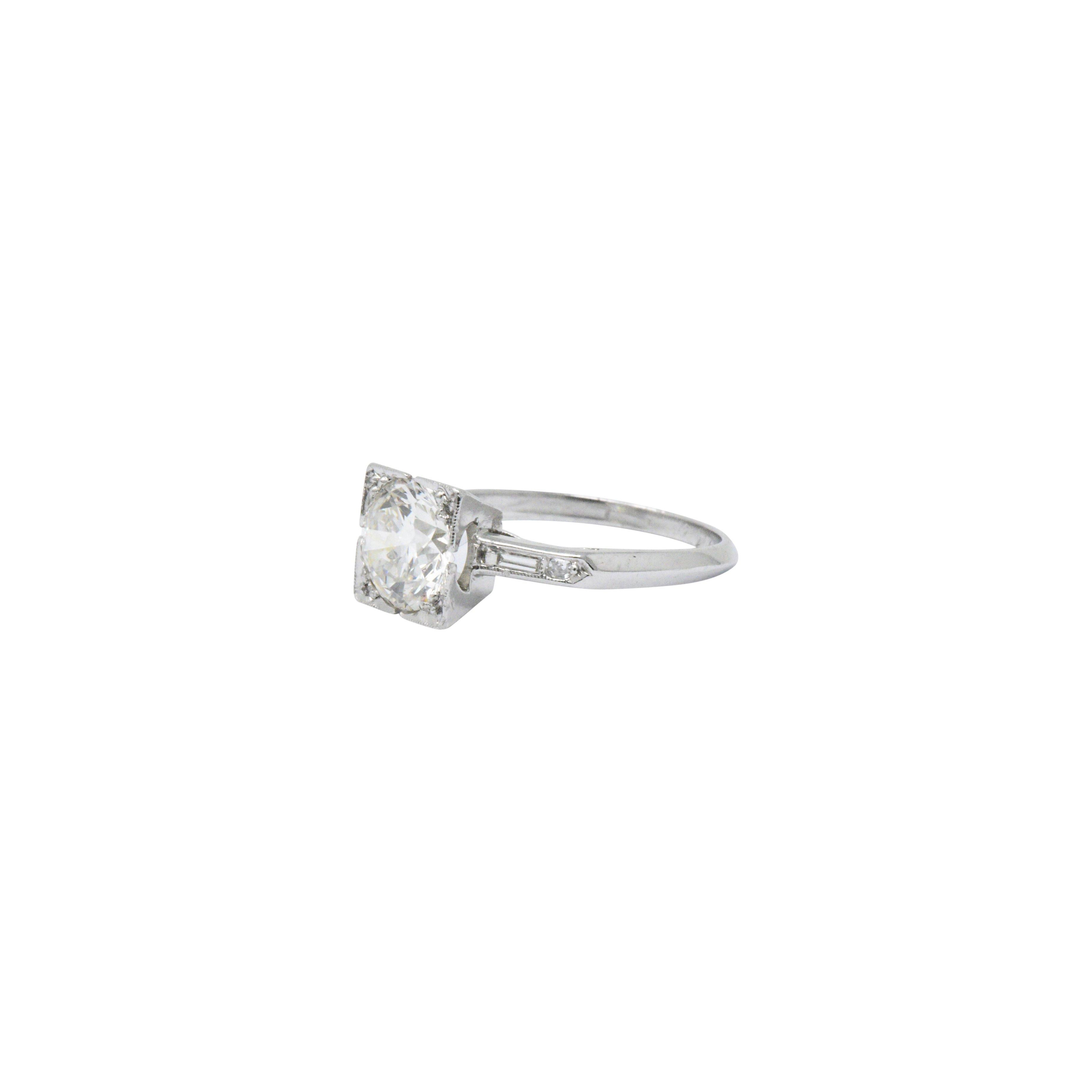 Centering a round brilliant cut diamond, set in a square form head, weighing 1.57 carats; I Color with VS1 clarity

Flanked by single cut and baguette cut diamond shoulders weighing approximately 0.18 carat; eye-clean and white

 Completed by knife