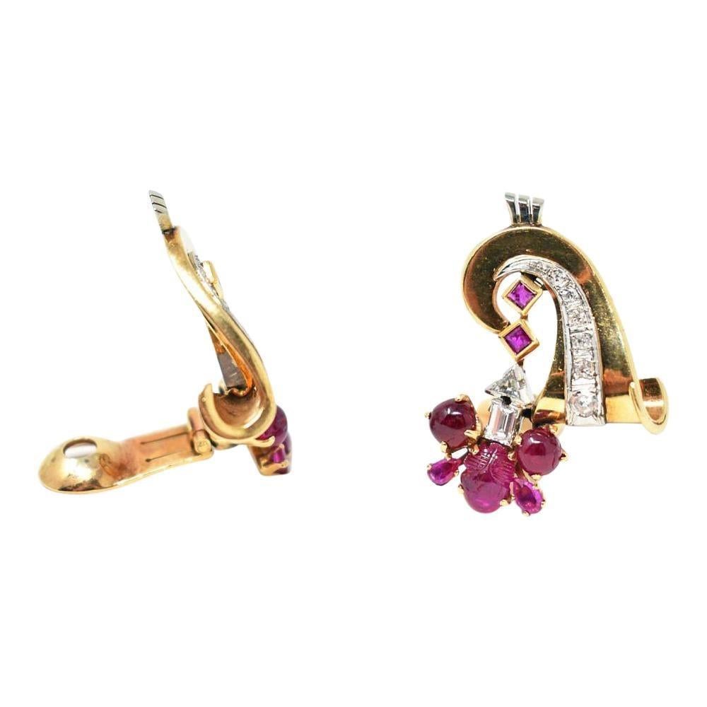 Retro 18k yellow and white gold ruby and diamond earrings
The rich Burmese rubies are carved crab cabochon and pear shaped, 4.5 carat total weight.  
.90 carat total weight of eye clean white baguette, triangular, and Swiss cut diamonds 
Earrings