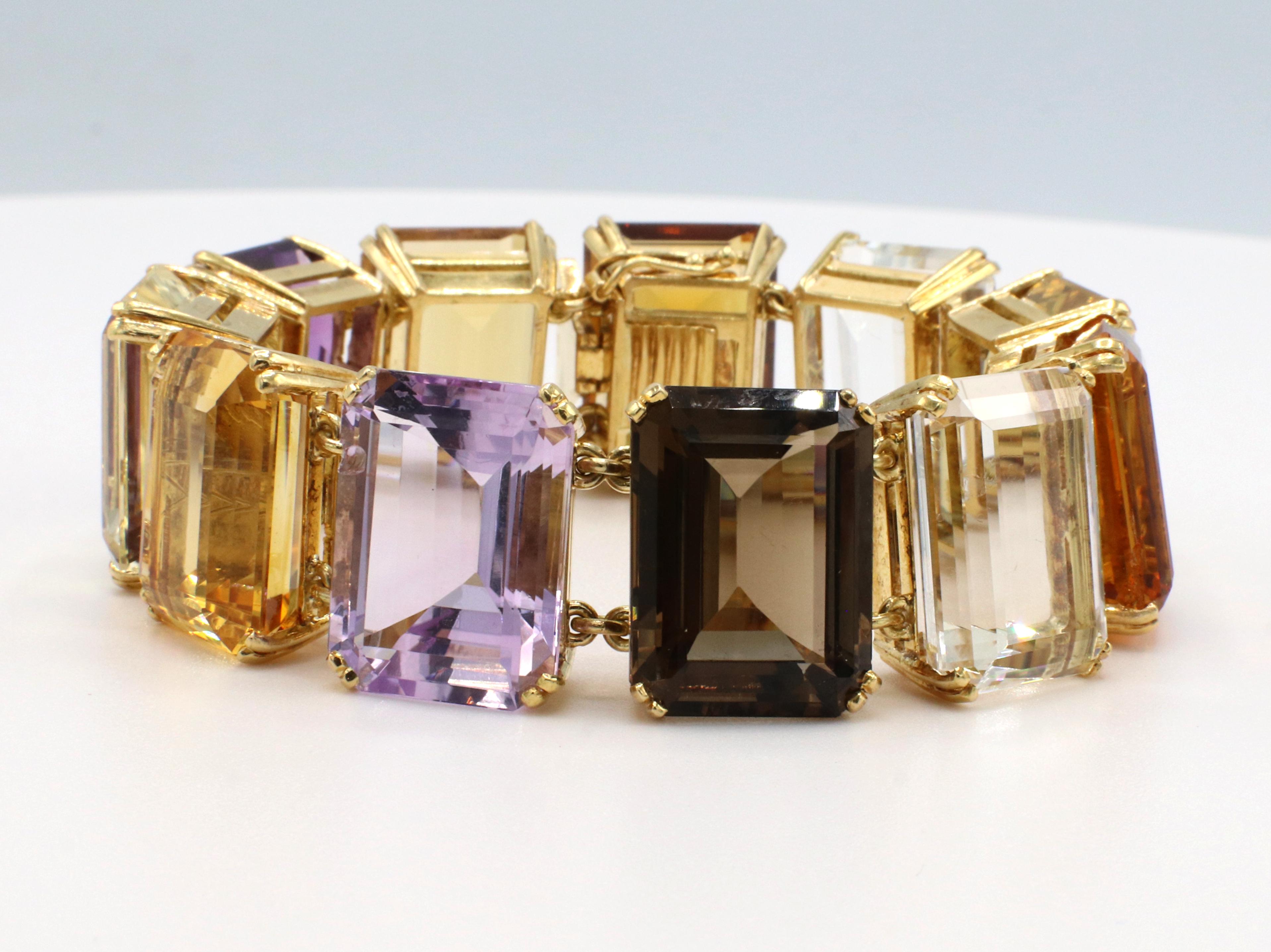 Retro 18 Karat Yellow Gold Multi-Colored Gemstone Bracelet 
Metal: 18k yellow gold
Weight: 97 grams
Length: 7.25 inches
Width: 20mm
Gemstones: Citrine, Amethyst, Topaz. Each stone is approx. 23 carats (253 CTW)
