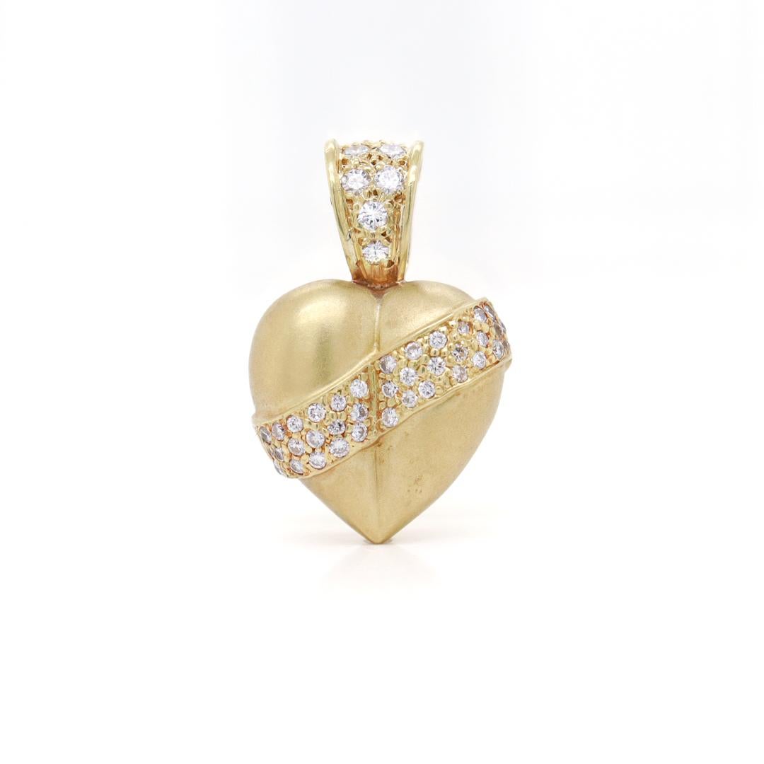 A fine 'puffy' heart gold & diamond pendant.

In 18k yellow gold with both a brushed and high polish finish.

Pave set with 40 small round cut white diamonds. 

(Cord for modeling only and not included).

Simply a wonderful Retro
