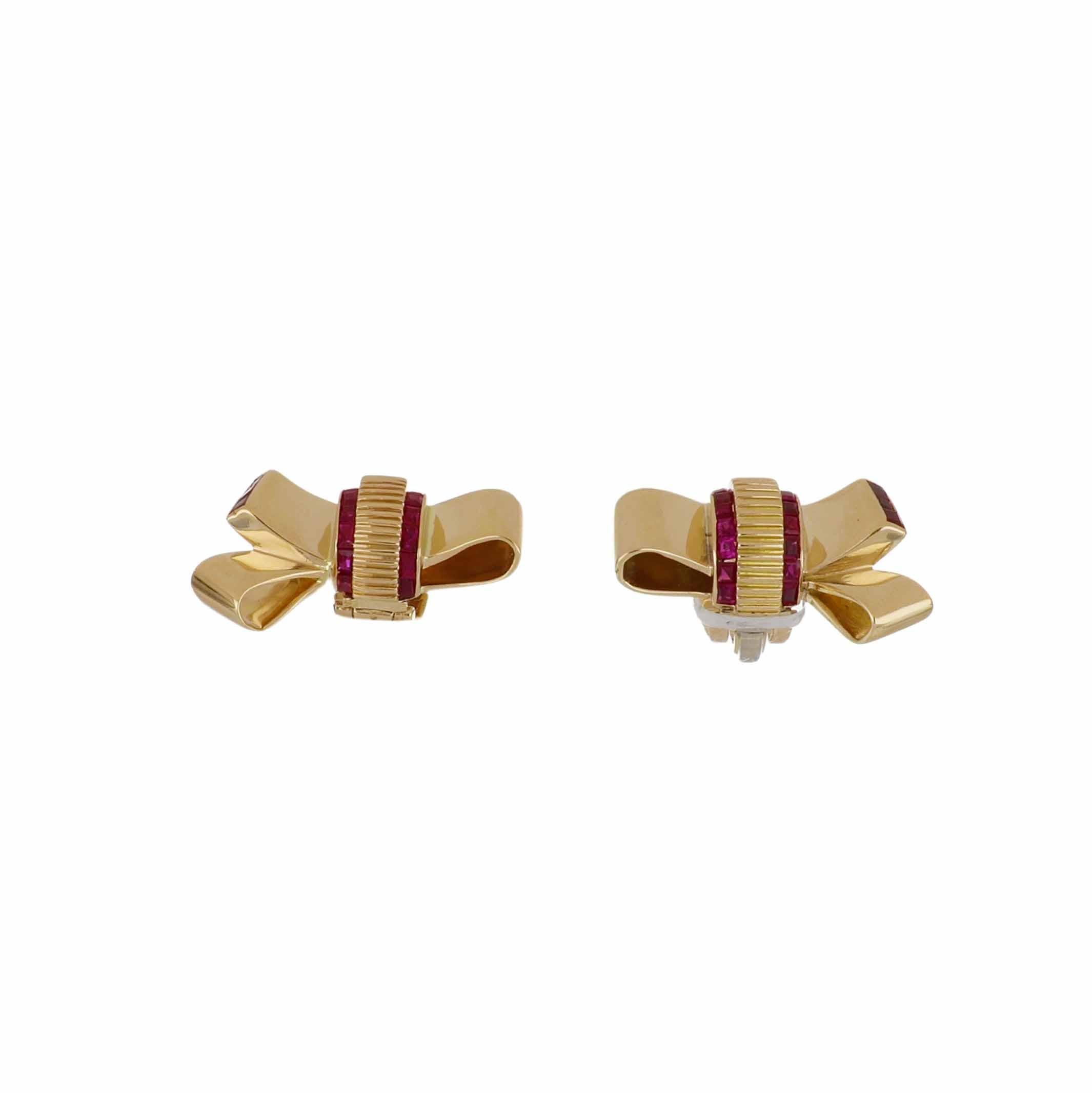 A pair of Retro 18K yellow gold three-dimensional folded ribbon clip earrings with a textured centerpiece, set with calibré-cut rubies. Circa 1940.

The thirty eight calibré-cut rubies total 2.10 carats. The earrings measure 7/8 of an inch in