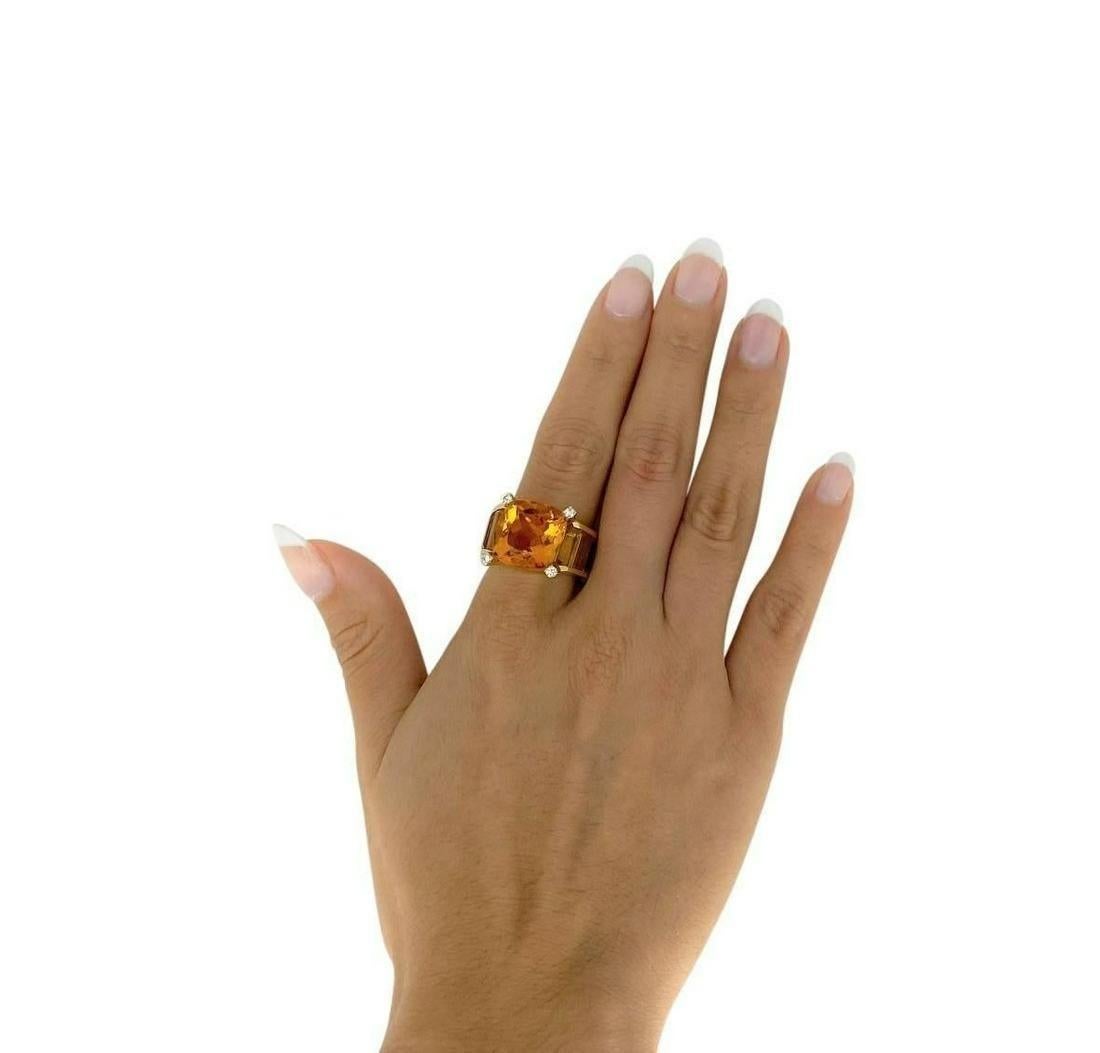 Signed MM Ring crafted in 18k yellow Gold, featuring one center cushion cut Natural Citrine weighing approximately 10.50 Carats. Accented with 4 Full cut Diamonds Approx. 0.12 Carats. H color, VS2 clarity. And 6 Baguettes Citrines on the shoulder.