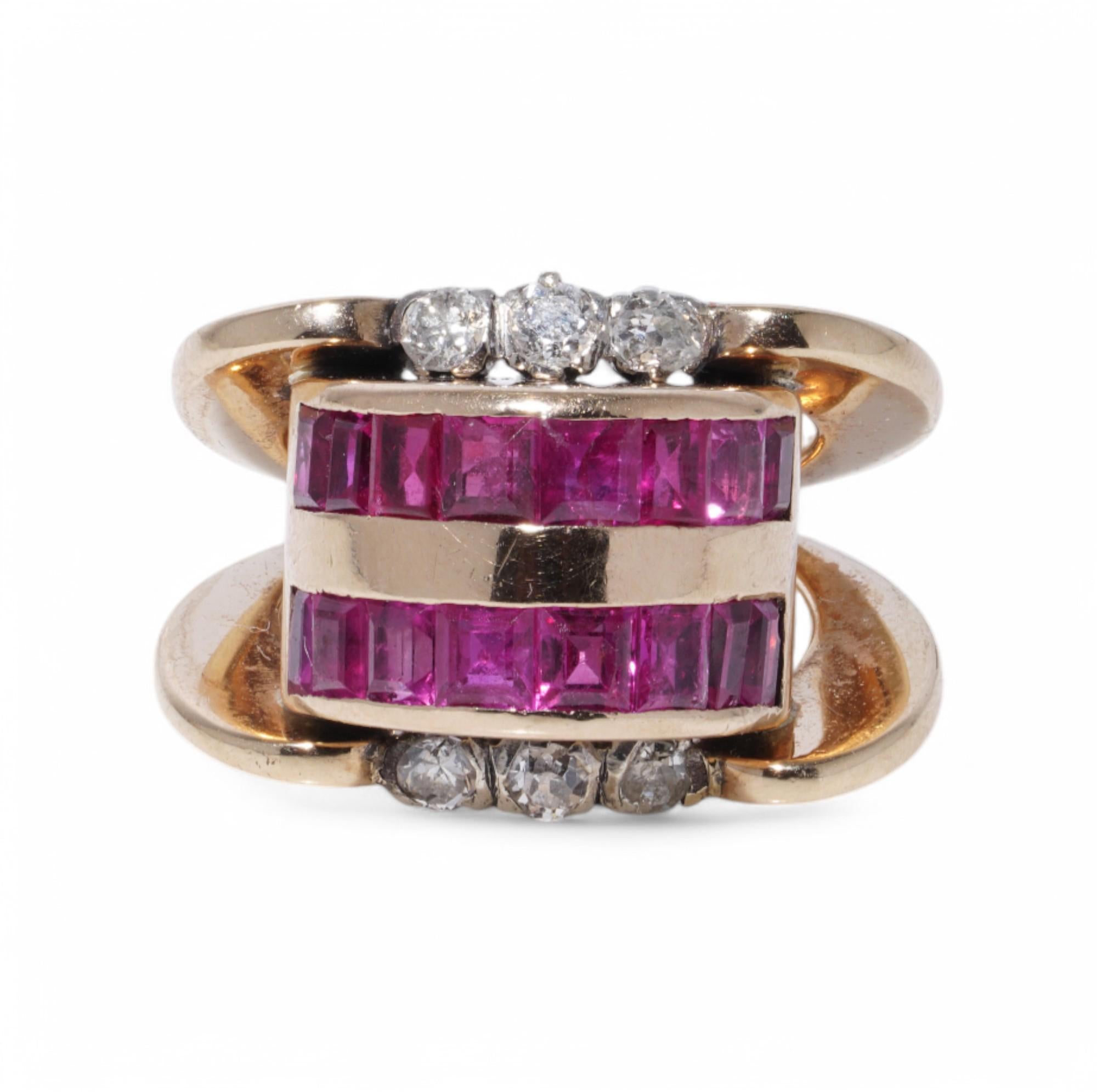 A bold Retro-period ring, circa 1940s, crafted in 18K yellow gold and silver, featuring a distinctive cylindrical design. The ring is adorned with 16 baguette-cut rubies, each approximately 0.16 carats, set in two channel-set rows. These vibrant
