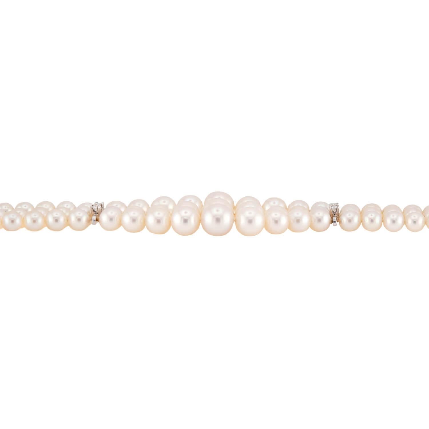 A gorgeous pearl and diamond multi-strand bracelet from the Retro (ca1940s) era! This stunning piece is comprised of 3 strands of delicate pearls, which have a rich creamy color and beautiful luster. The pearls vary slightly in size, with the larger