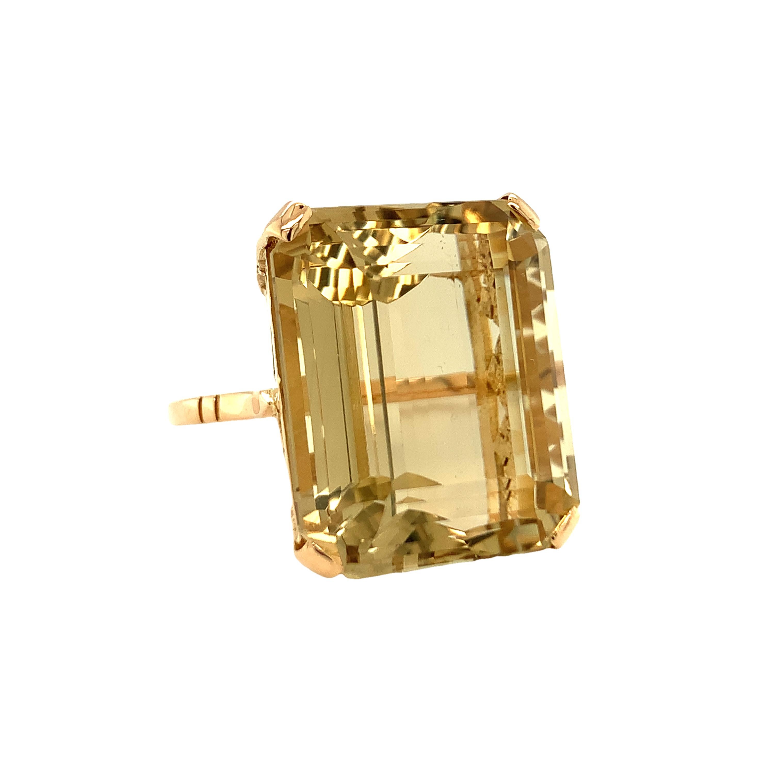 One Retro 18k rose gold citrine ring centering one prong set, emerald cut citrine weighing 42.30 ct. (actual weight) measuring 22 x 18 mm. With intricate designed basket mount.

Golden, grand, substantial.

Metal: 18K rose gold
Gemstone: Citrine =
