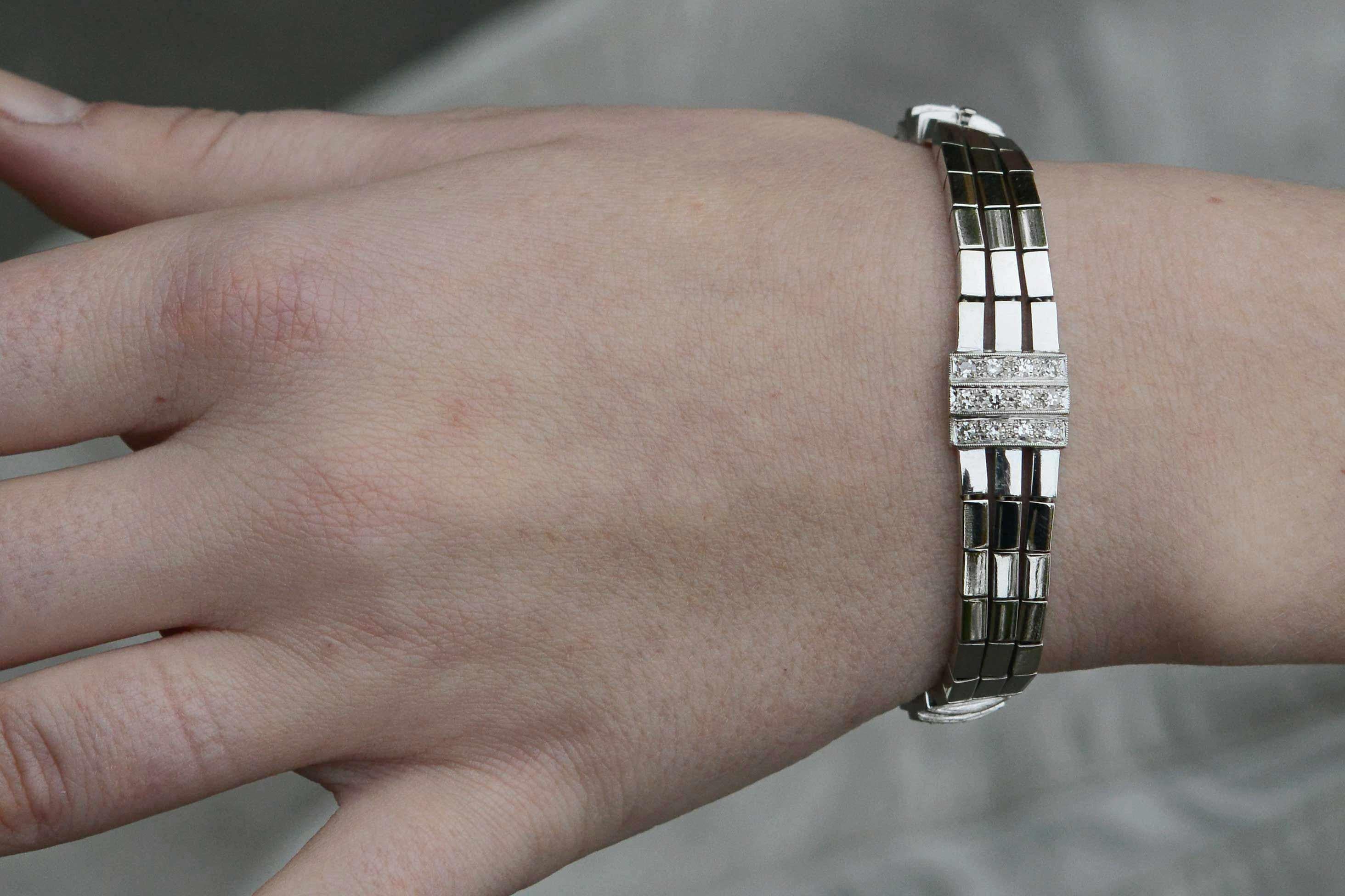 This luxurious retro bracelet remains in supreme style after 80 years. It's cubist architecture and sophisticated design generously promotes the 1.65 total carats of European cut diamonds. They are colorless and bead set into small and large