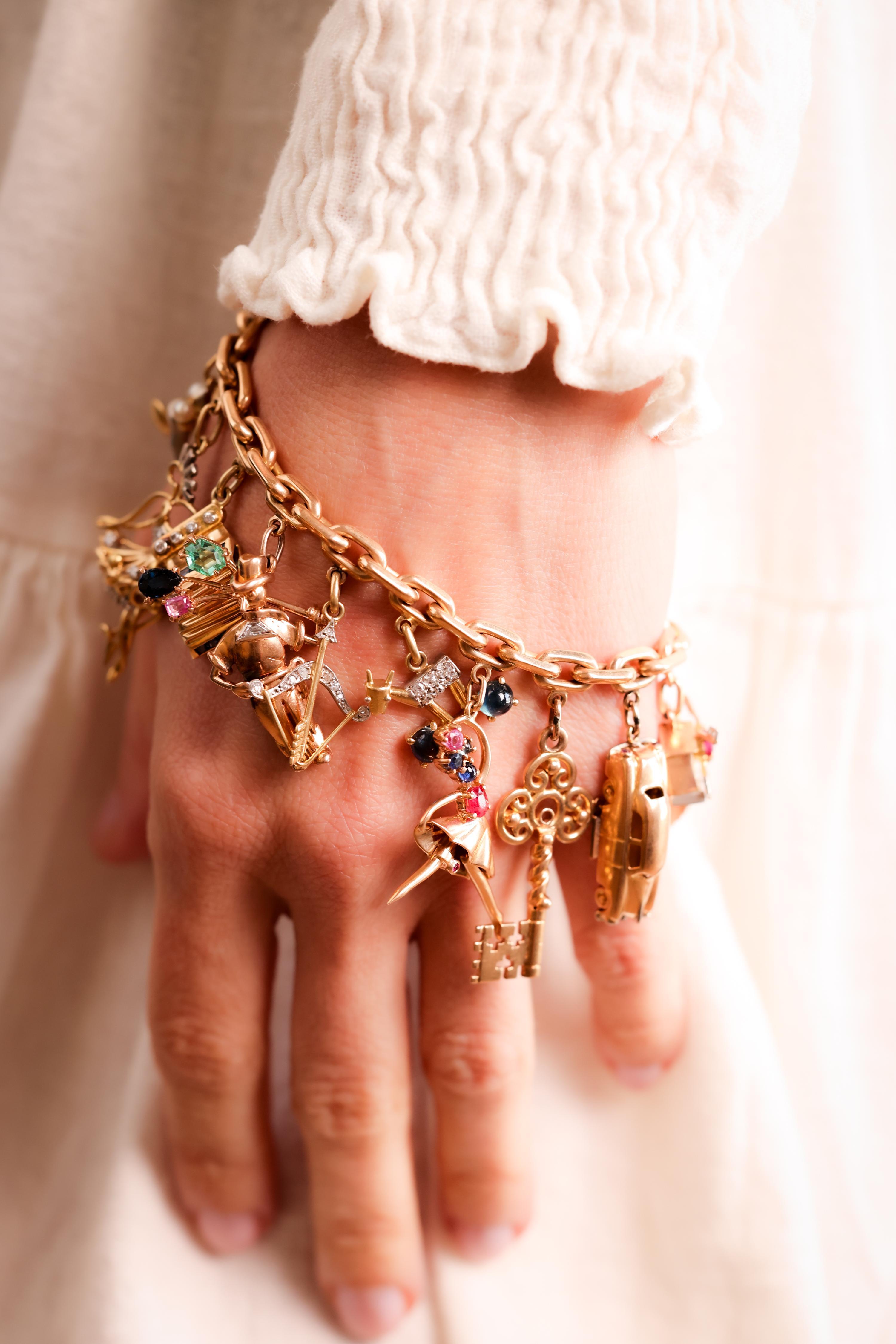 Bracelet and Charms Crafted in 18K Yellow and White Gold
Charm 1: Guitar
Center Stone: Diamond, Single Cut, I,VS, Approx. 0.01 Carats
Charm 2: Bouquet
Center Stone: Diamond, Single Cut, H, VS, Approx. 0.01 Carats
Charm 3: Cowboy Hat
Charm 4: