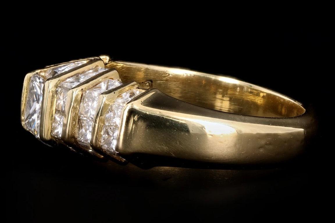 Retro 18k yellow gold .50 carat princess cut diamond ring

Era: Retro
Composition: 18K Yellow Gold 
Primary Stone: Princess Cut Diamond
Carat Weight: Approximately .50 Carats
Color/Clarity: G/VS2
Accent Stone: Twenty-Eight Princess Cut & Two