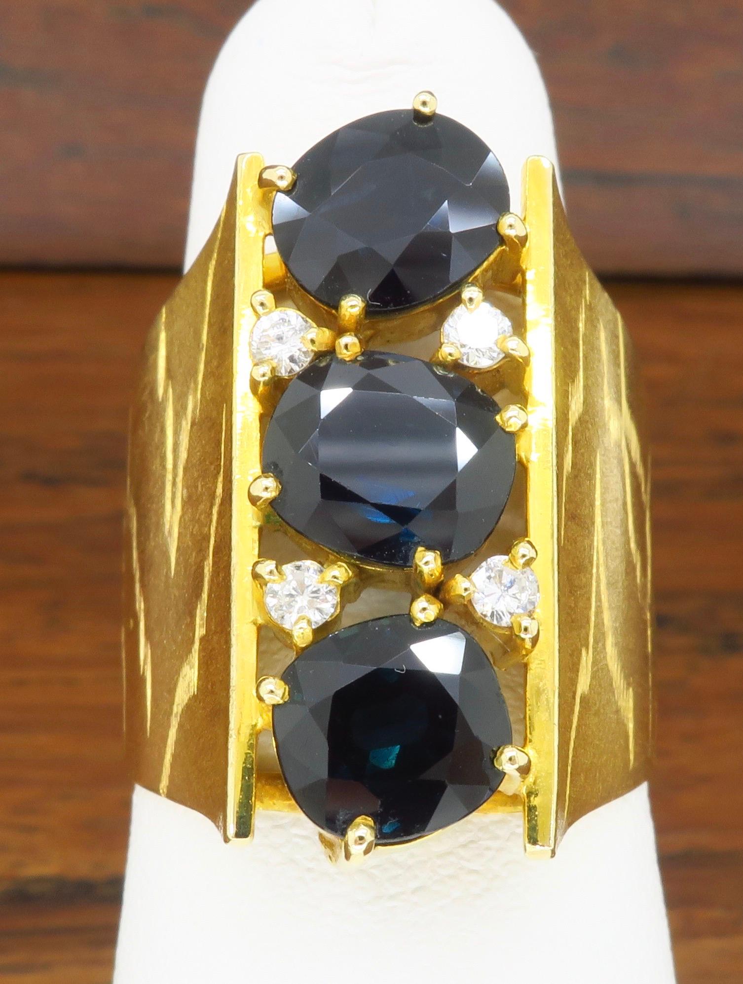 Retro Oval Blue Sapphire & Diamond ring made in 18k yellow gold. 

Gemstone: Blue Sapphire & Diamonds
Diamond Carat Weight:  .12CTW
Metal: 18k Yellow Gold 
Marked/Tested: Tested 18k 
Weight: 11.7 Grams
Ring Size: 5.5 - 6