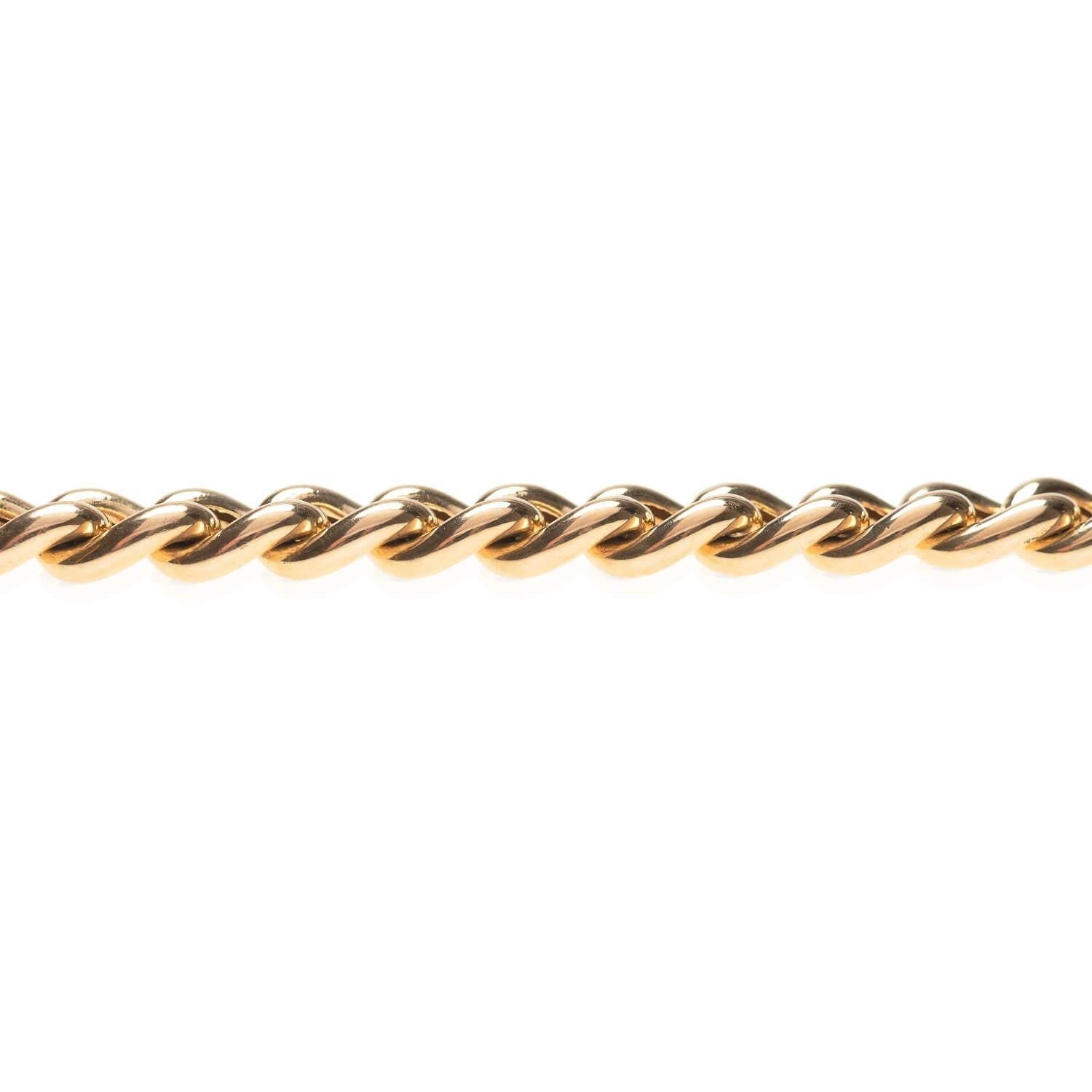 A classic curb link bracelet from the Retro (ca1940s) era! Crafted in vibrant 18kt yellow gold, this bracelet features rounded, hollow curb links that form a straight but flexible design. A push clasp is hidden below the links, marked 