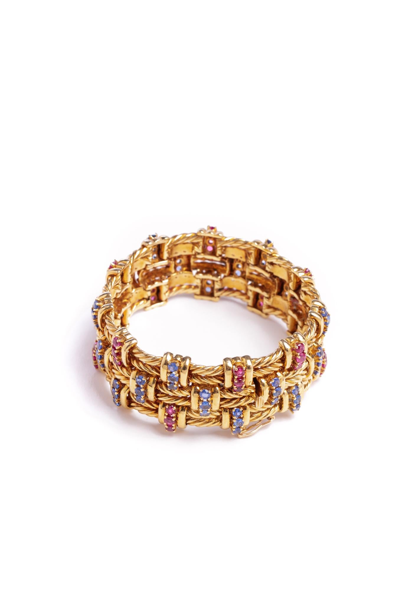 18kt yellow gold woven bracelet with approximately 6cts of rubies and sapphires.
