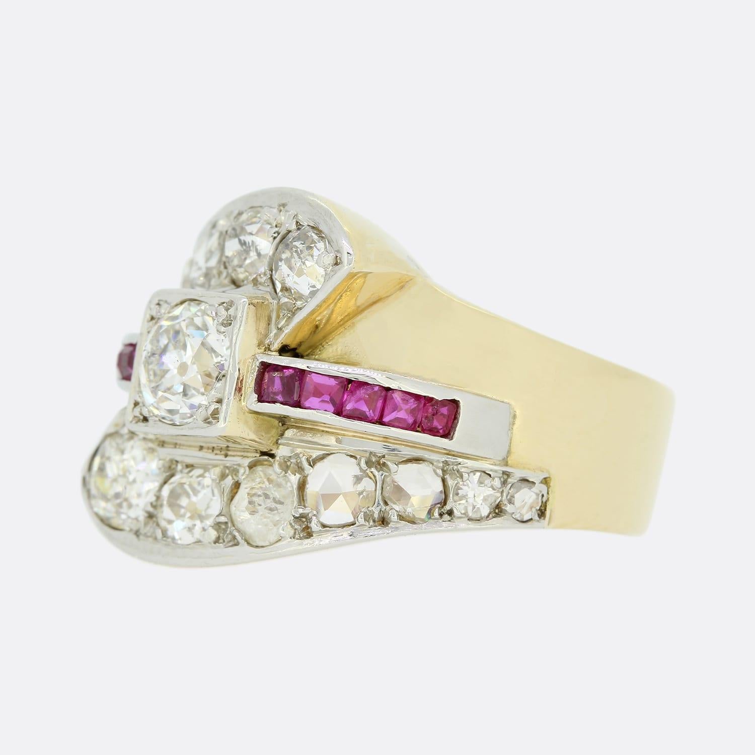 This is a Vintage 18ct yellow gold diamond crossover ring. The ring has been set with a central chunky old cut diamond with 5 rubies on each shoulder and 14 diamonds that are set on the overlapping shoulders. The diamonds on the shoulders are old