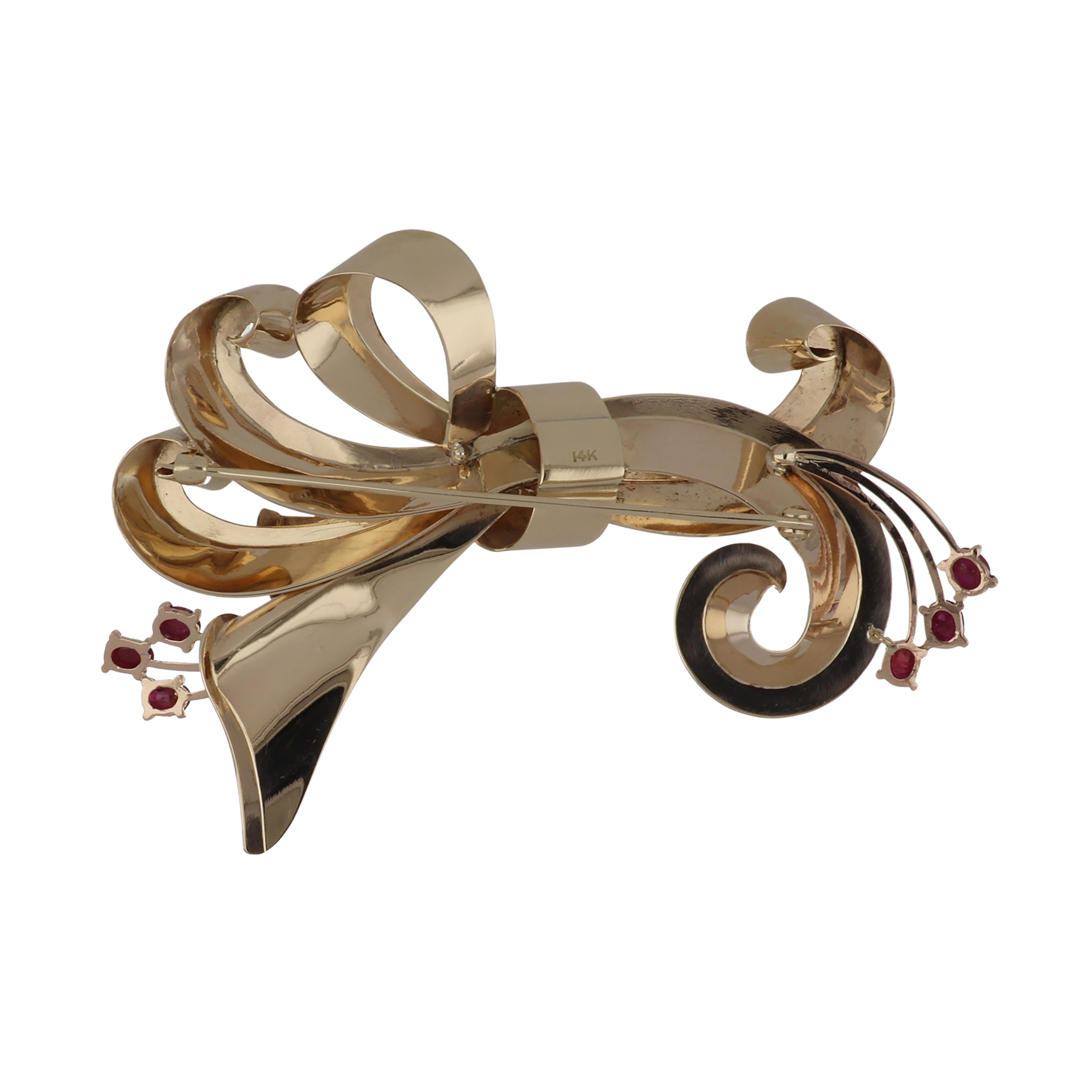 Retro 14K yellow gold stylized bow brooch set with oval cabochon rubies. Circa 1940. 