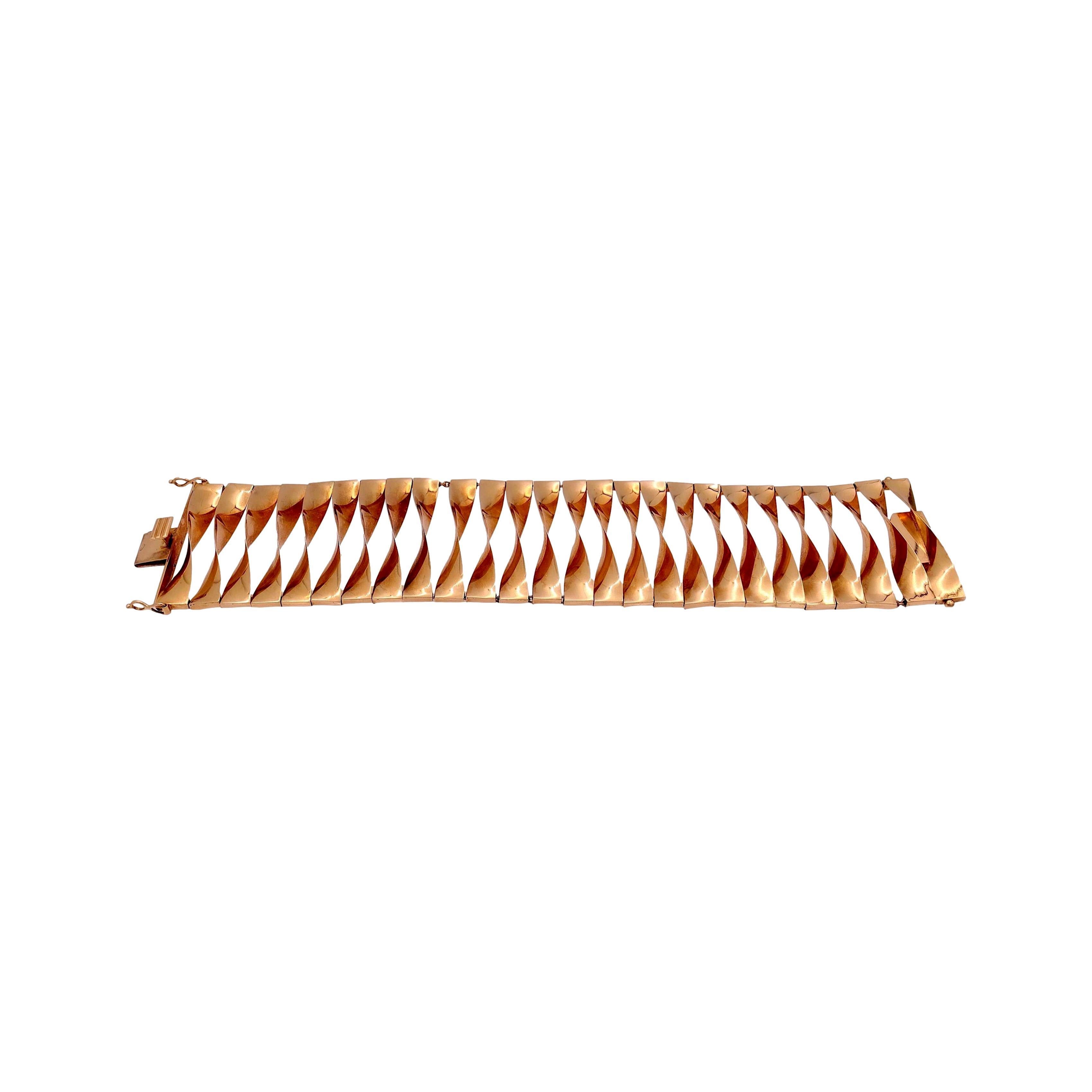 1940's retro bracelet finely crafted in 14 Karat rose gold featuring an open scroll work swirl design. Bracelet preserves patina. The bracelet measures 1.5