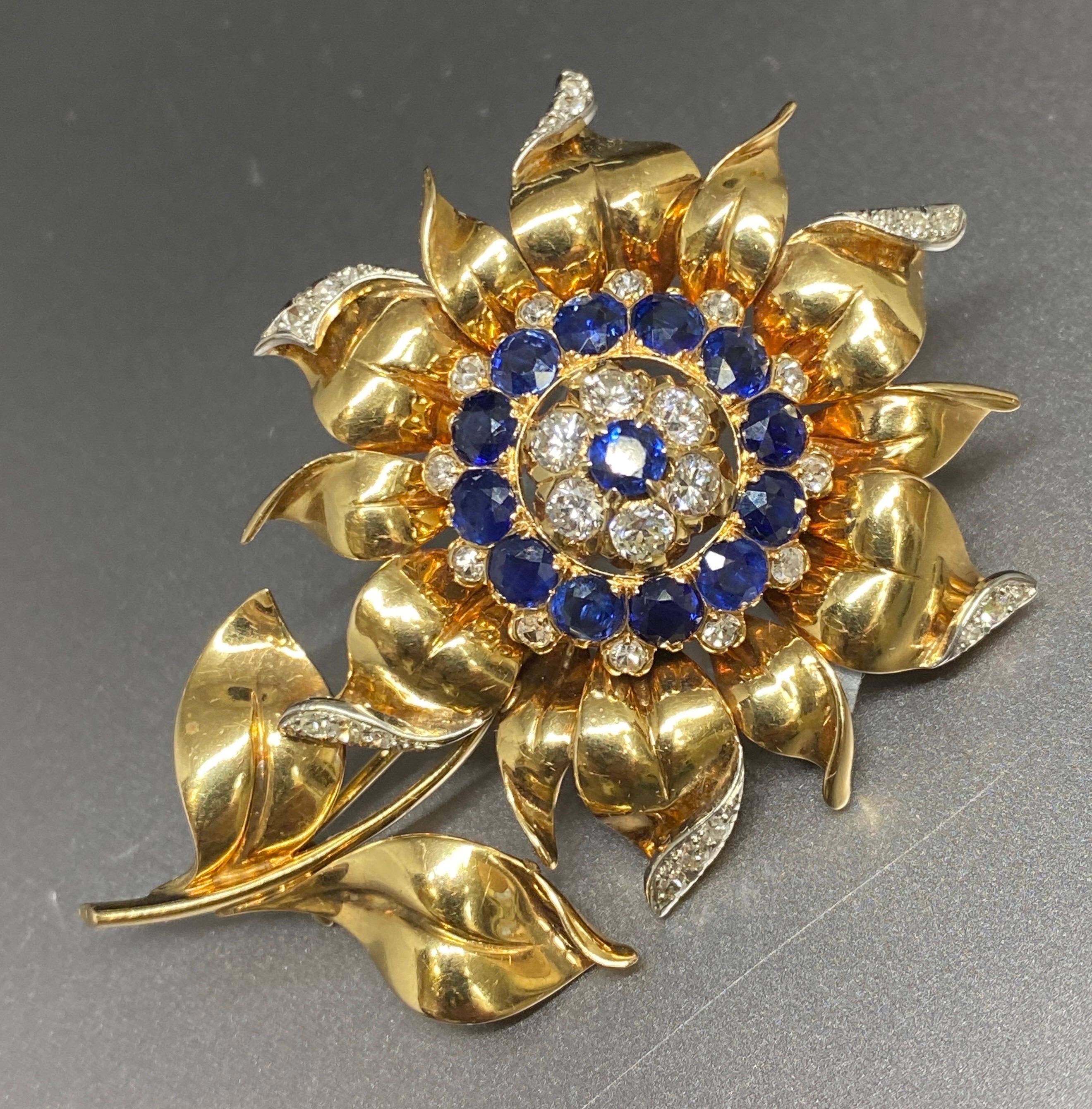 Up for your consideration is this superb floral brooch circa 1940's.
A true stunner this brooch is finely made of 14k yellow gold and features a domed center of sparkling gems alternating between rows of fine natural round brilliant cut and single