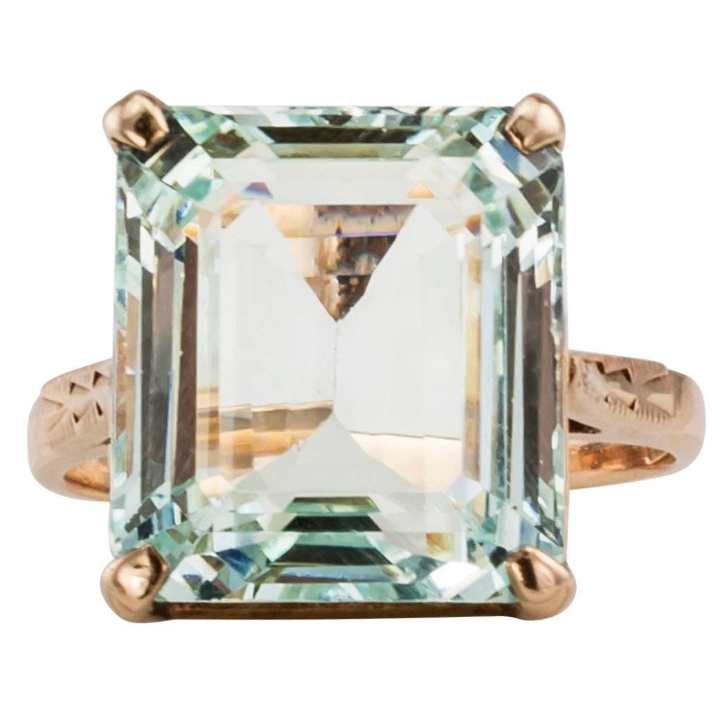 Retro 1940s emerald cut aquamarine and gold cocktail ring. The design showcases an emerald-cut aquamarine weighing approximately 11.00 carats on an authentic, Retro, 1940's 14-karat gold mounting. The aquamarine displays a vibrant blue color with