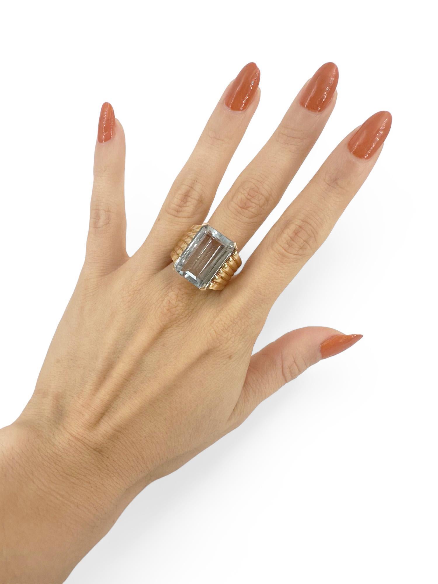 Introducing a stunning Retro 18kt yellow gold ring, featuring a magnificent emerald cut aquamarine weighing approximately 17.0 carats. This exquisite gemstone is the centerpiece of the ring, showcasing its captivating blue hue that evokes the serene