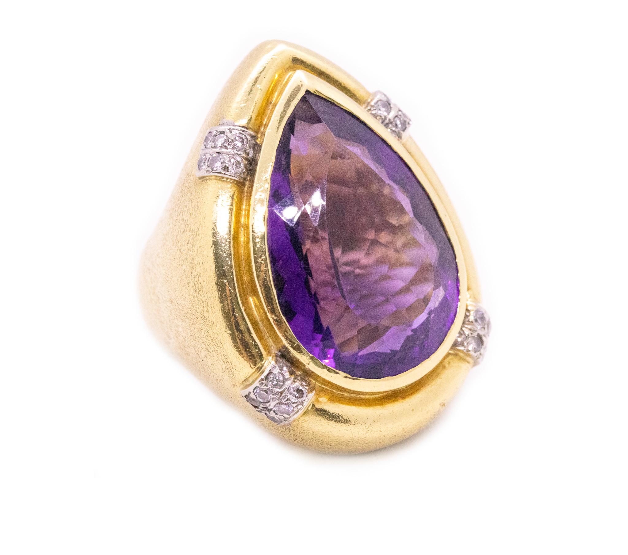 An over-sized jeweled cocktail ring.

Surely a one-of-a-kind custom made piece, created in the early 1970's period. It was crafted, with a massive huge look in solid yellow gold of 18 karats, with textured hammered surfaces and white gold accents