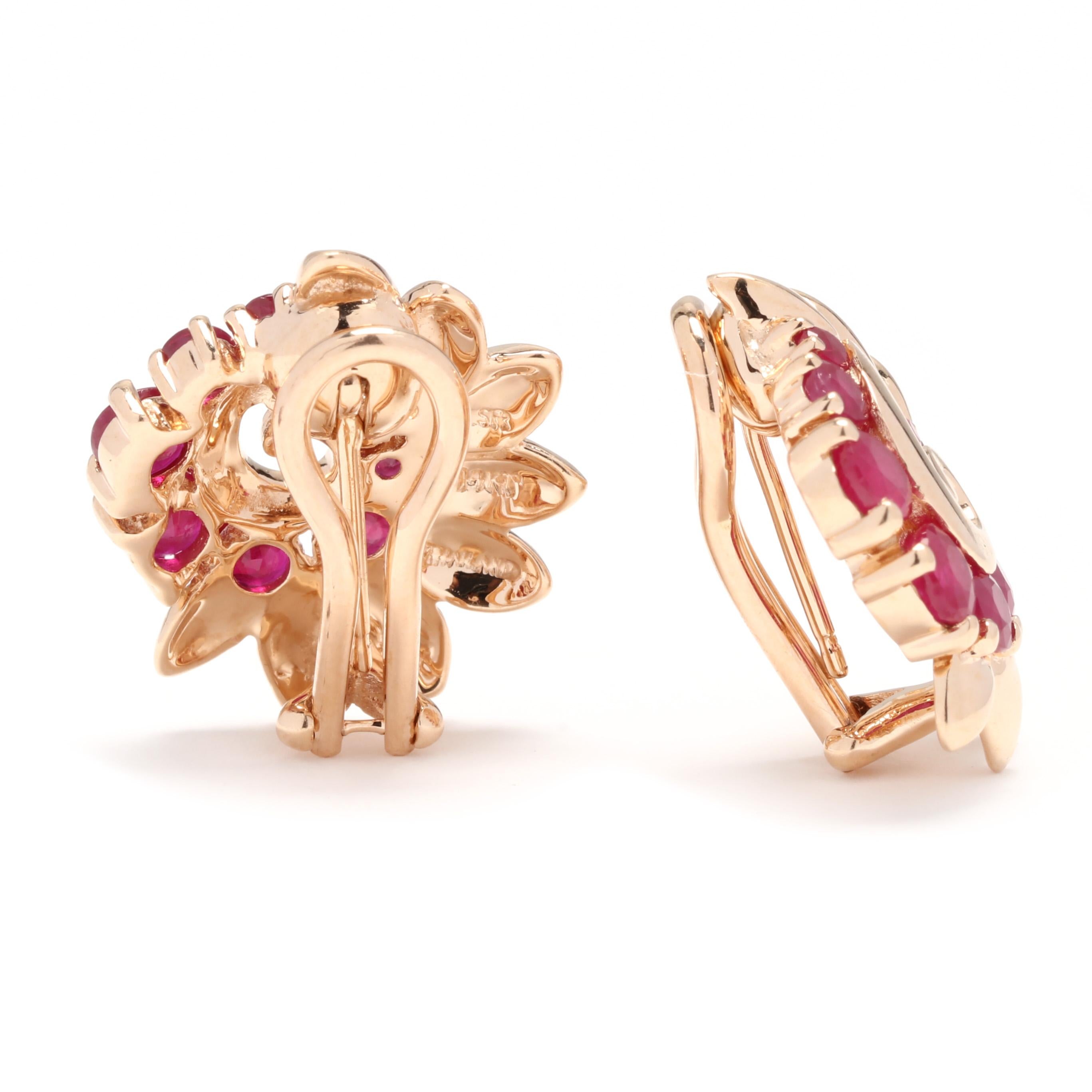 A pair of retro 14 karat yellow gold ruby swirl earrings. These classic earrings feature a swirl motif of gold marquise accents with round cut rubies weighing approximately 1 total carat and with collapsible post clip on backs.

Stones:
- ruby, 18