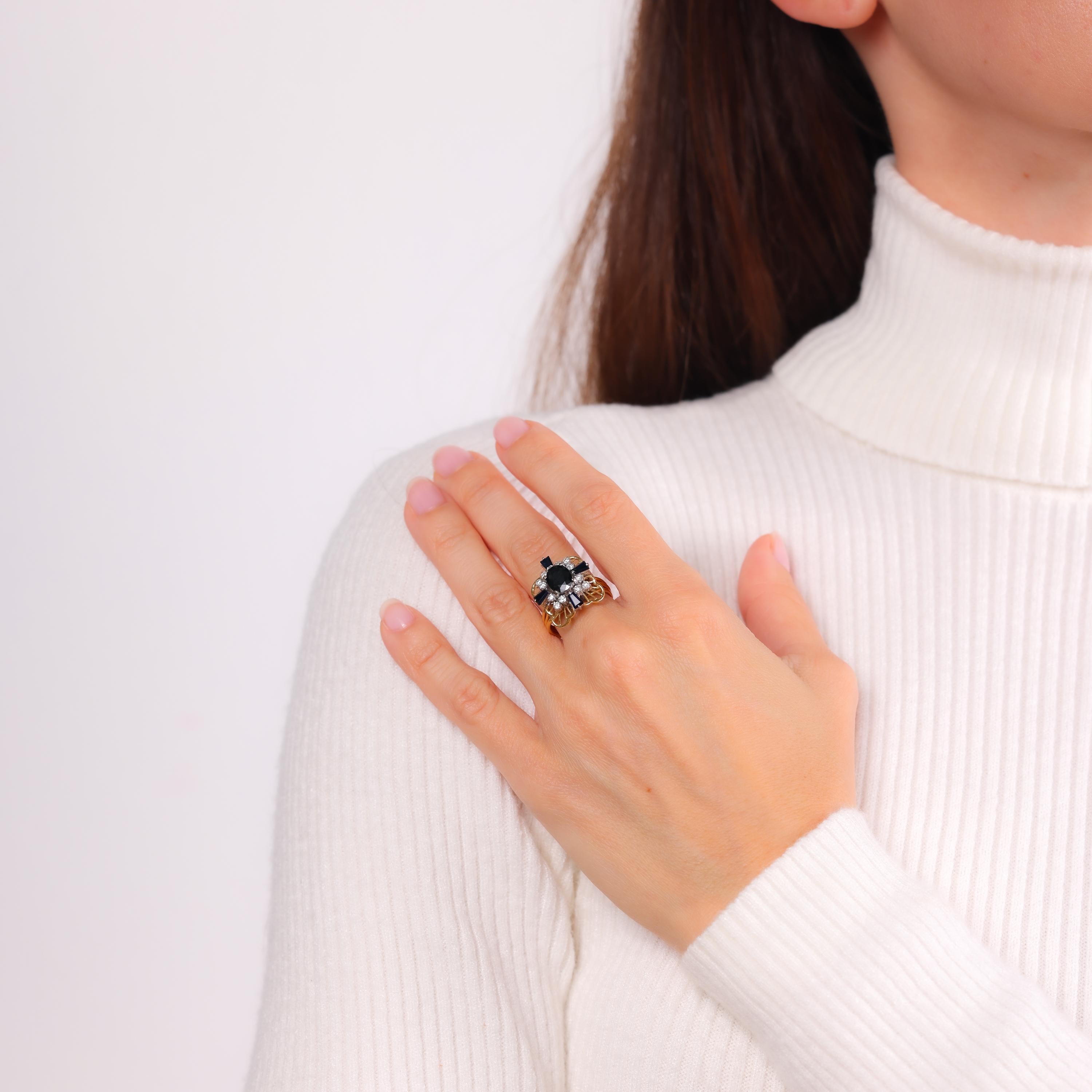This Retro cocktail ring combines vibrant blue sapphires and sparkling diamonds in a bold 18k yellow and white gold setting, exuding timeless elegance from the 1940s.

Total sapphire weight: Approximately 2 carats
Center stone: One oval cut blue
