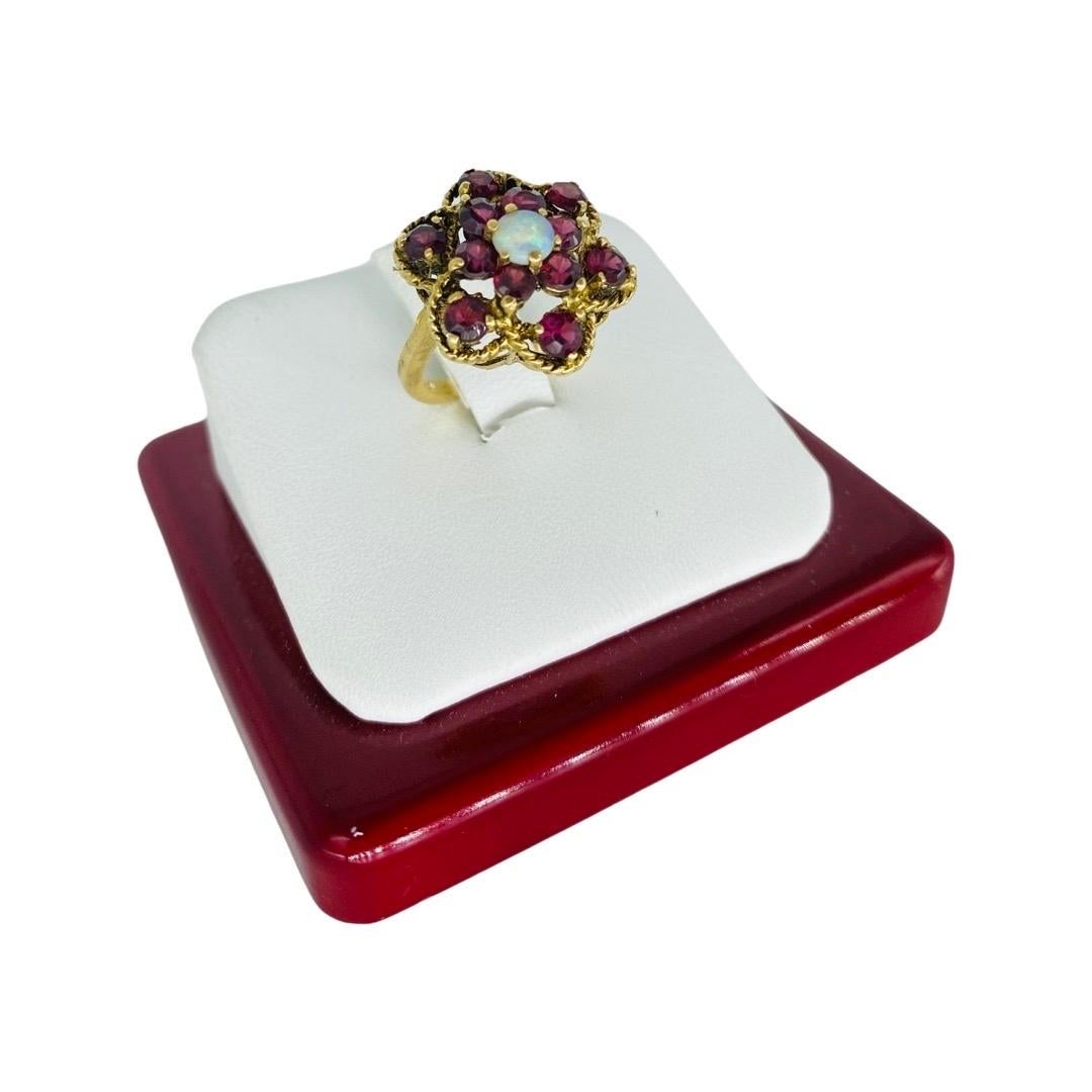 Retro Tourmaline and Opal Cluster Flower Ring 14k
The ring features approx 1.80 carat total weight of red tourmaline stones and a center opal weighting approx 0.20 carat.
The ring is a size 4.5 and weights 4.3 grams in 14k gold.