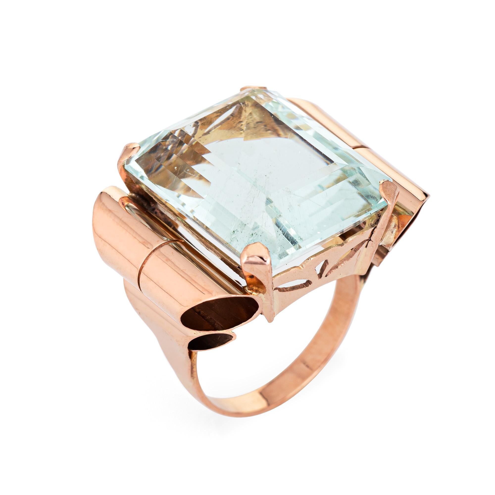 Stylish Retro vintage aquamarine cocktail ring (circa 1940s) crafted in 14 karat rose gold. 

Emerald cut aquamarine measures 20mm x 15mm (estimated at 20 carats). The aquamarine is in very good condition and free of cracks or chips. 

The clear as