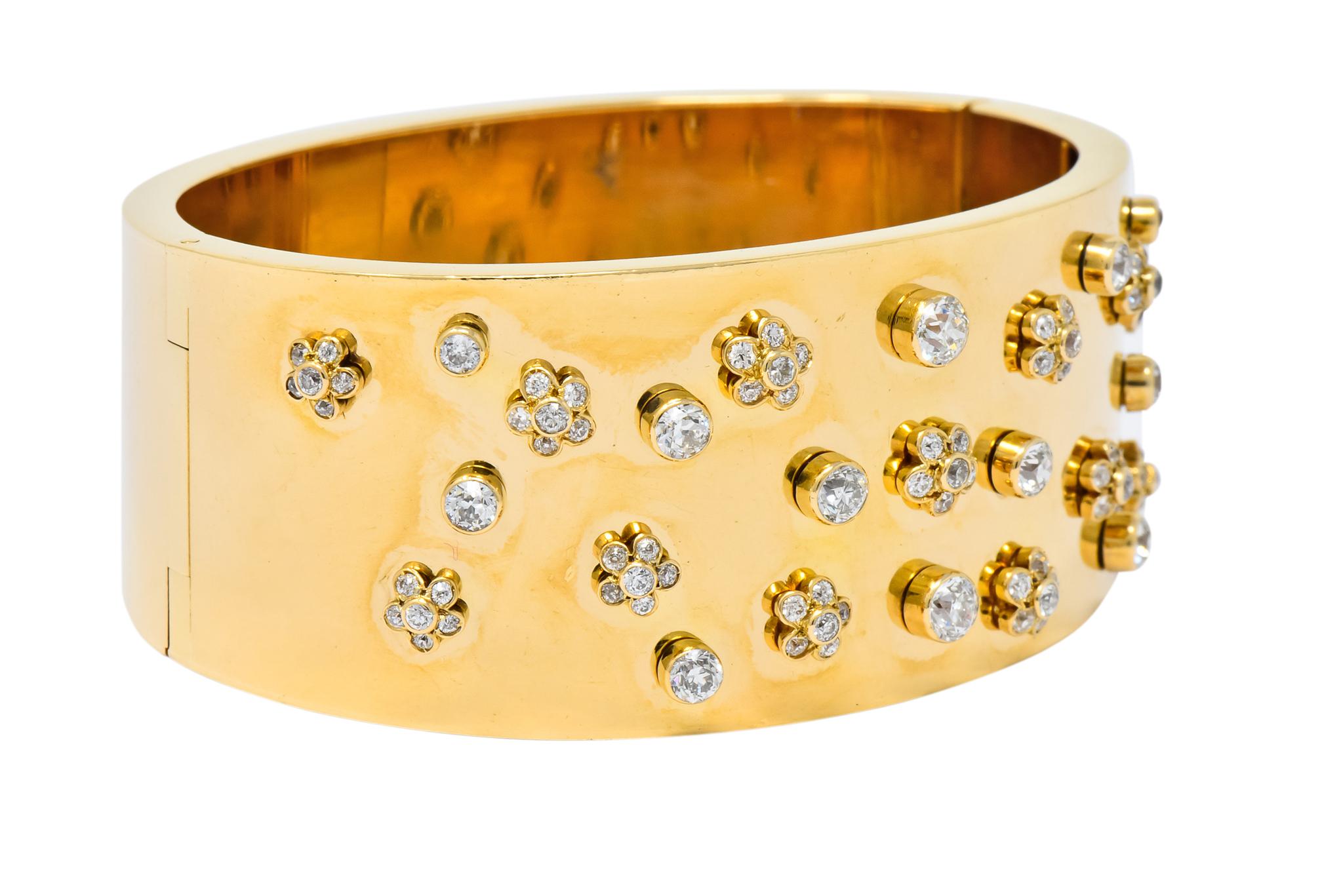 Wide bangle style gold bracelet with a high polished finish

Set to front with old European cut diamonds weighing approximately 2.28 carats total, H/I color and VS clarity

Bezel set in floral motifs with single stone accents

Completed by concealed