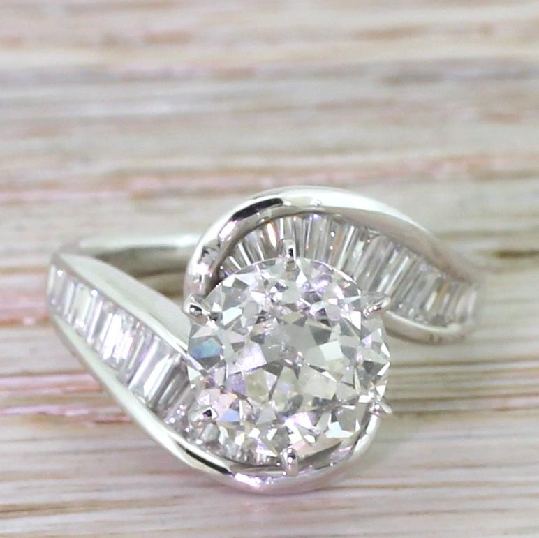 Utterly, utterly immense. The central old European cut diamond is secured in an eight-claw collet with an open gallery, allowing maximum light to shine through the stone. The curving and undulating shank holds thirty baguette cut and tapered