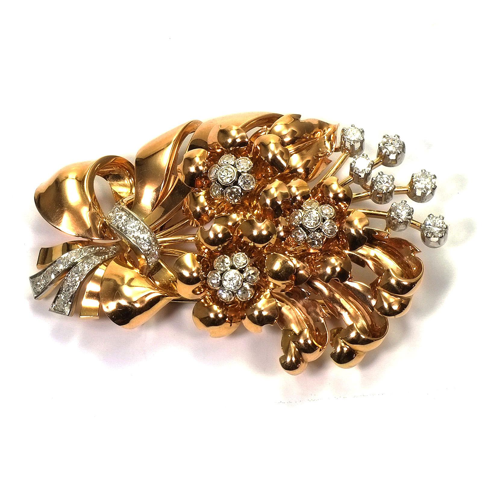 Retro 2.5 carat diamond and rose gold flower bouquet brooch circa 1945

This representative rose gold diamond brooch is designed as a magnificent bouquet of flowers with naturalistically worked blossoms and leaf tendrils, set with sparkling diamonds