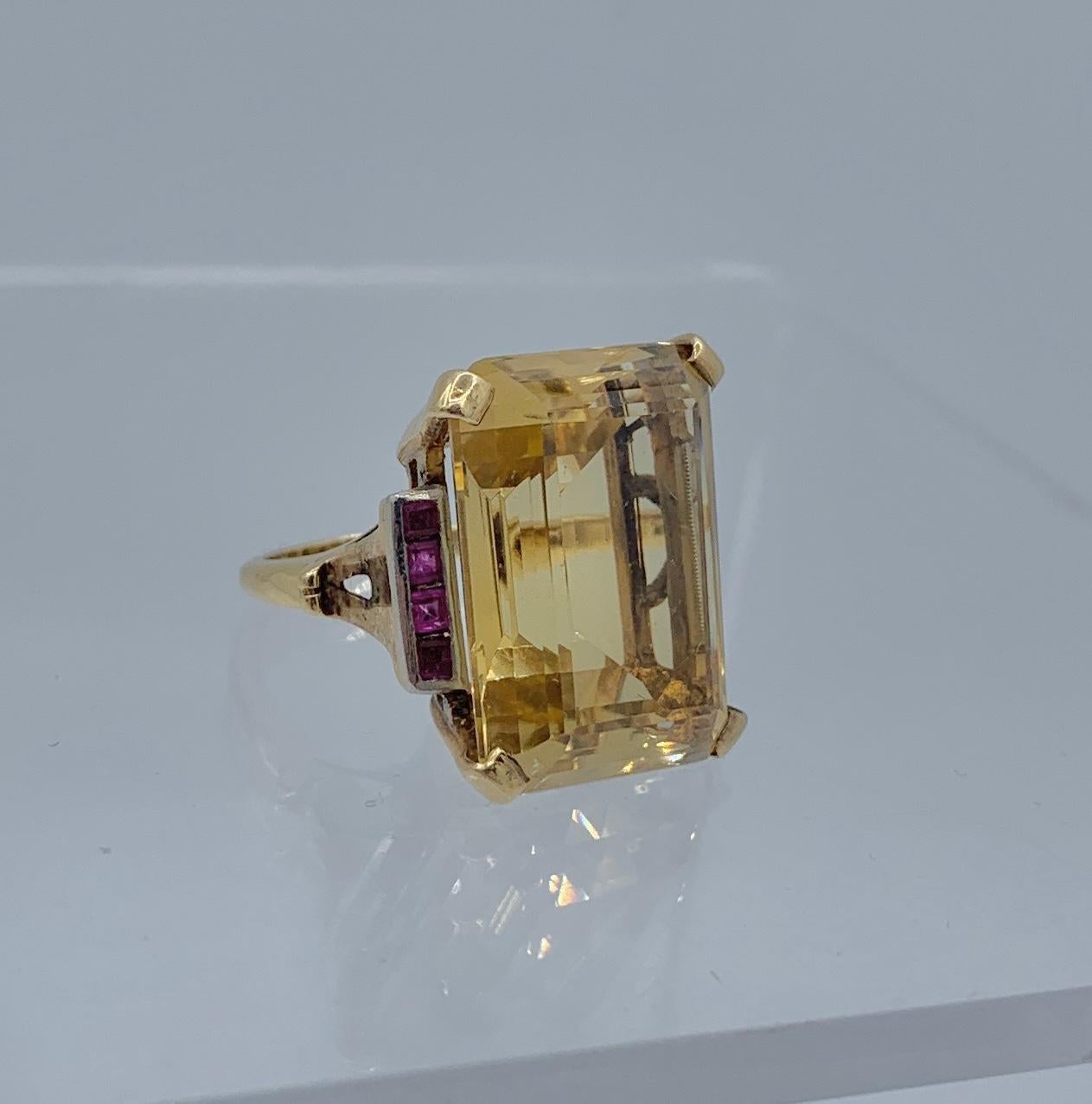 This is an absolutely magnificent antique monumental 28 Carat emerald cut Citrine Ring with Ruby and Diamond gems in a classic Art Deco - Hollywood Regency setting in 14 Karat Gold.  The ring is a testament to the stunning design of the Art Deco