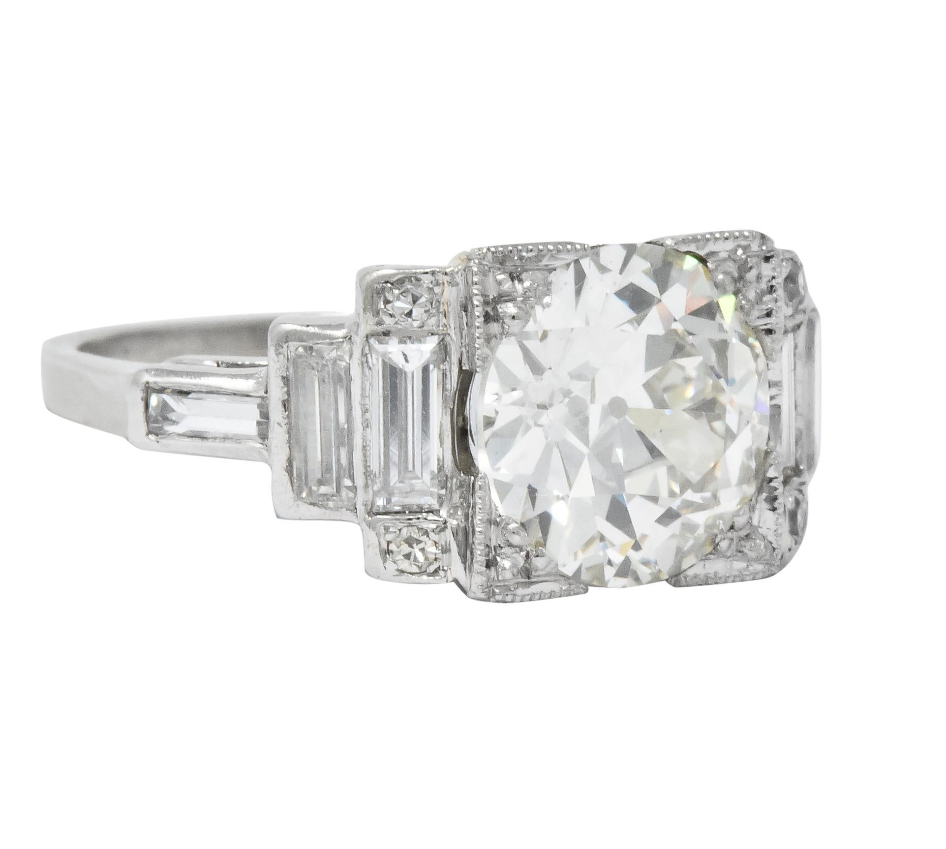 Centering an old European cut diamond set in a square form head weighing 2.84 carats, L color and VS1 clarity

Flanked by bezel set baguette cut diamonds in stepped design with bead set single cut diamond accents weighing approximately 0.45 carat