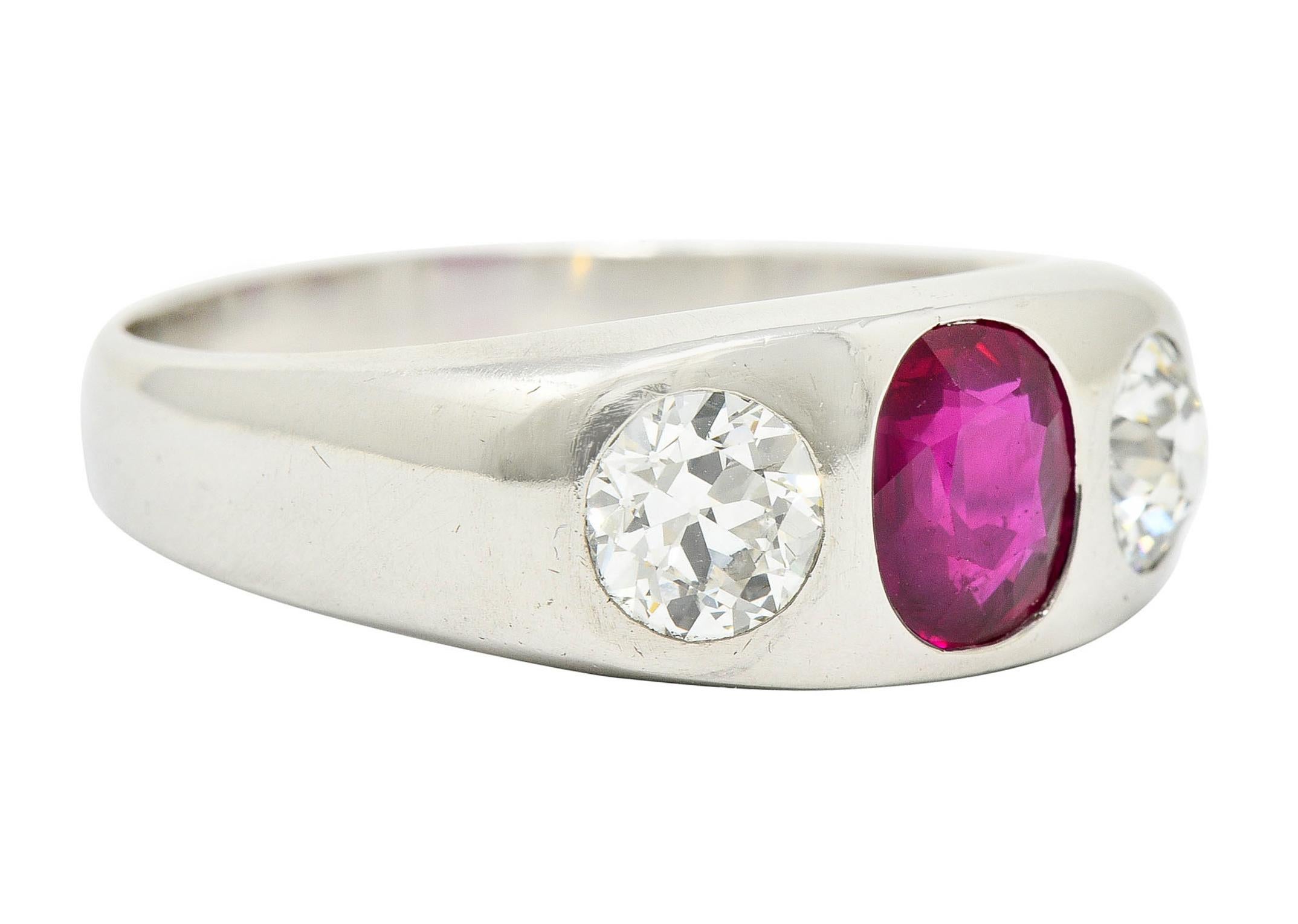 Gypsy style ring centers a flush set oval cut Burma ruby

Weighing 1.89 carats with bright purplish red color and no indications of heat

Flanked by two flush set transitional cut diamonds

Weighing in total approximately 1.50 carats with I/J color
