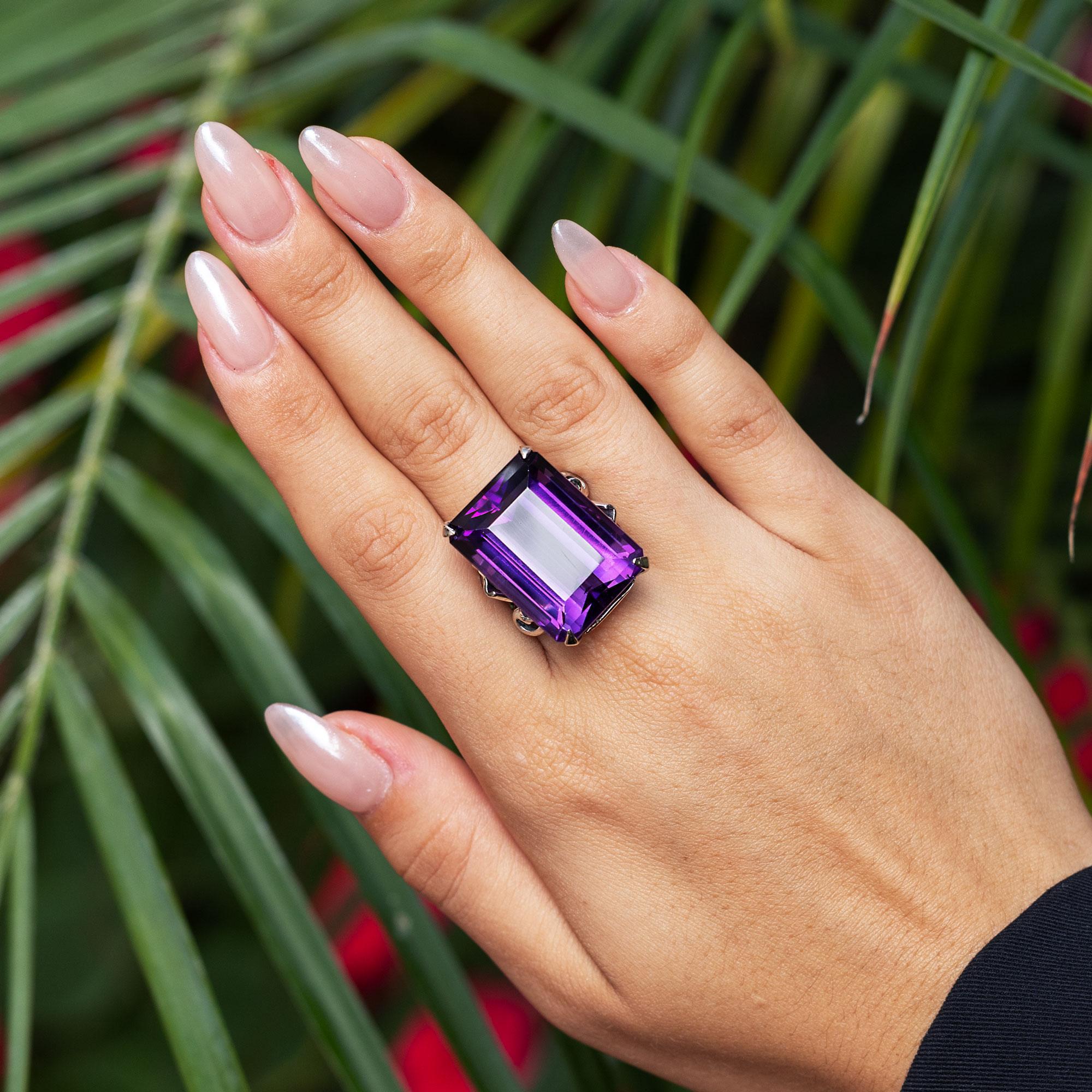 This retro estate cocktail ring is a rare find at an amazing value, and perfect for your vintage collection. Bespoken with 14 karat white gold, the golden scrolled band is embellished with a dazzling and lovely-hued violet amethyst, weighing 40