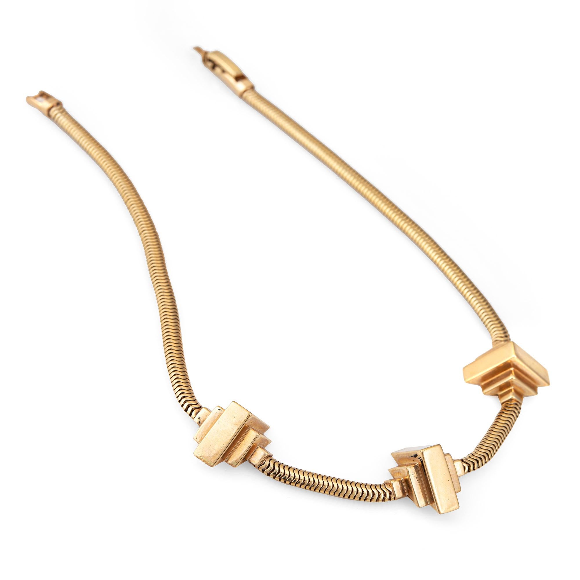 Stylish and finely detailed retro vintage snake chain necklace crafted in 14 karat yellow gold (circa 1940s).  

Three architectural style 'stations' offer a bold look to this stunning retro necklace. The snake chain is soft to the touch and moves