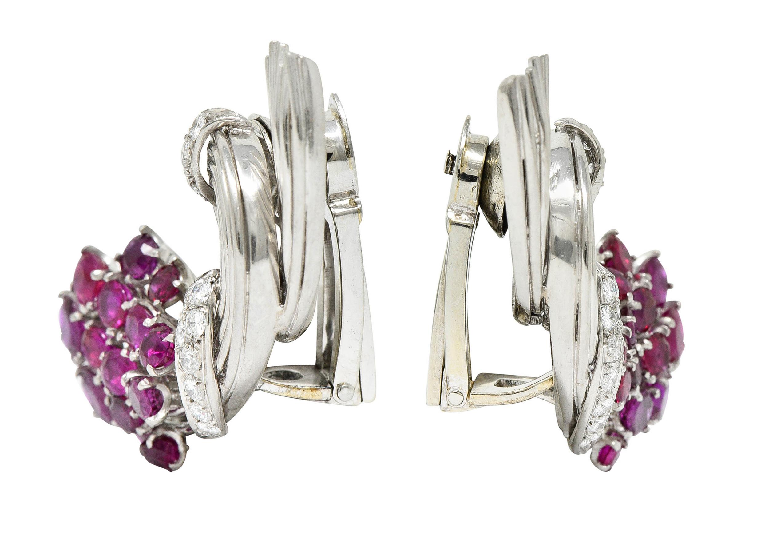 Ear-clip earrings are designed as spiraled bouquets

Featuring clustered round cut rubies weighing in total approximately 4.00 carats

Transparent to translucent and strongly purplish red in color

Accented by round brilliant cut diamonds weighing