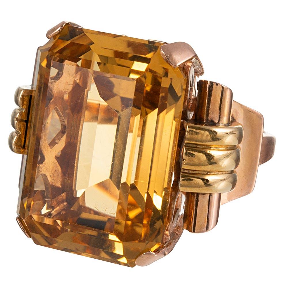 Classic retro styling, with scrolling strokes of 18 karat yellow and rose gold accent a 50 carat citrine in glamourous fashion. The bold size of the ring makes it suitable for cocktail attire while the absence of diamonds allow it to also be worn