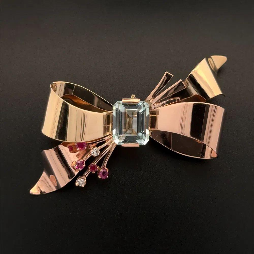 Simply Beautiful! Finely detailed Rose and Green 2-tone Gold Retro Brooch. Centering a securely nestled Hand set 6 Carat Aquamarine. Enhanced with Diamonds, weighing approx. 0.10tcw and Rubies, approx. 0.28tcw. Hand crafted 2-tone Rose and Green