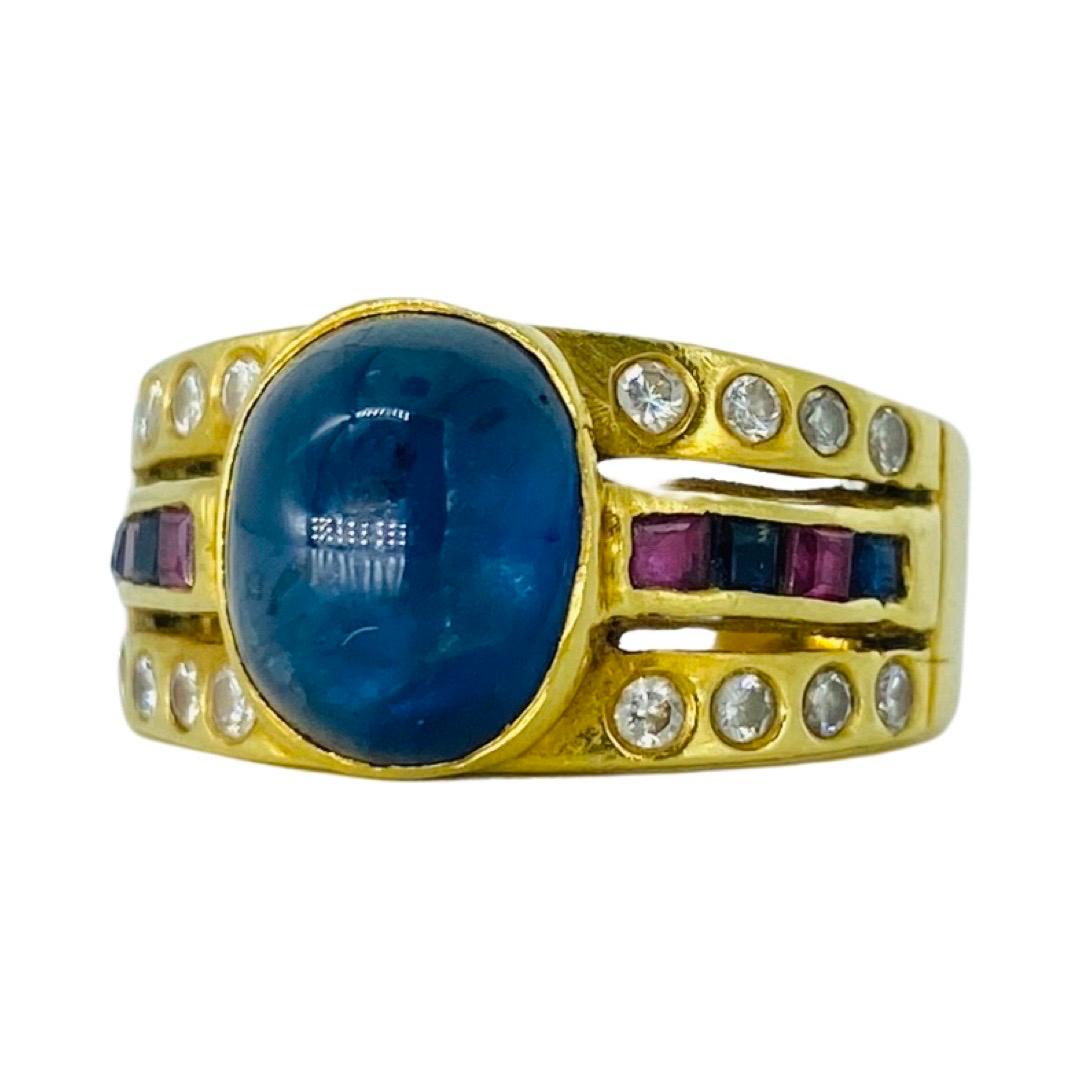 Retro 6.00 Carat Sapphire Cabochon, Rubys and Diamonds Ring 18k solid Gold. Very impressively made by designer. The square Rubys and sapphires on the side of the ring are channel set and the round diamonds on the sides of the ring are bezel set.