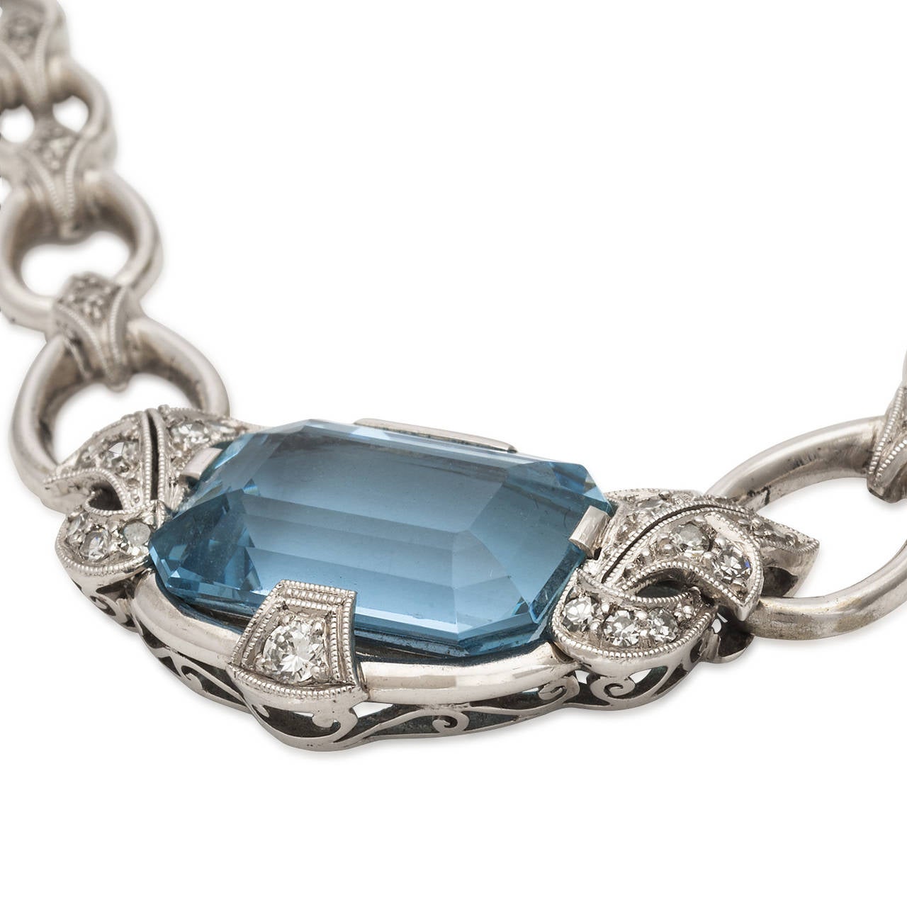 The aquamarine 5.5ct TW in this necklace has a brilliant blue color and clarity that is unusual to find in such a large stone. The color is accentuated by the 23 diamonds TW of 0.2ct set in 18k white gold. The style is definitely Retro.