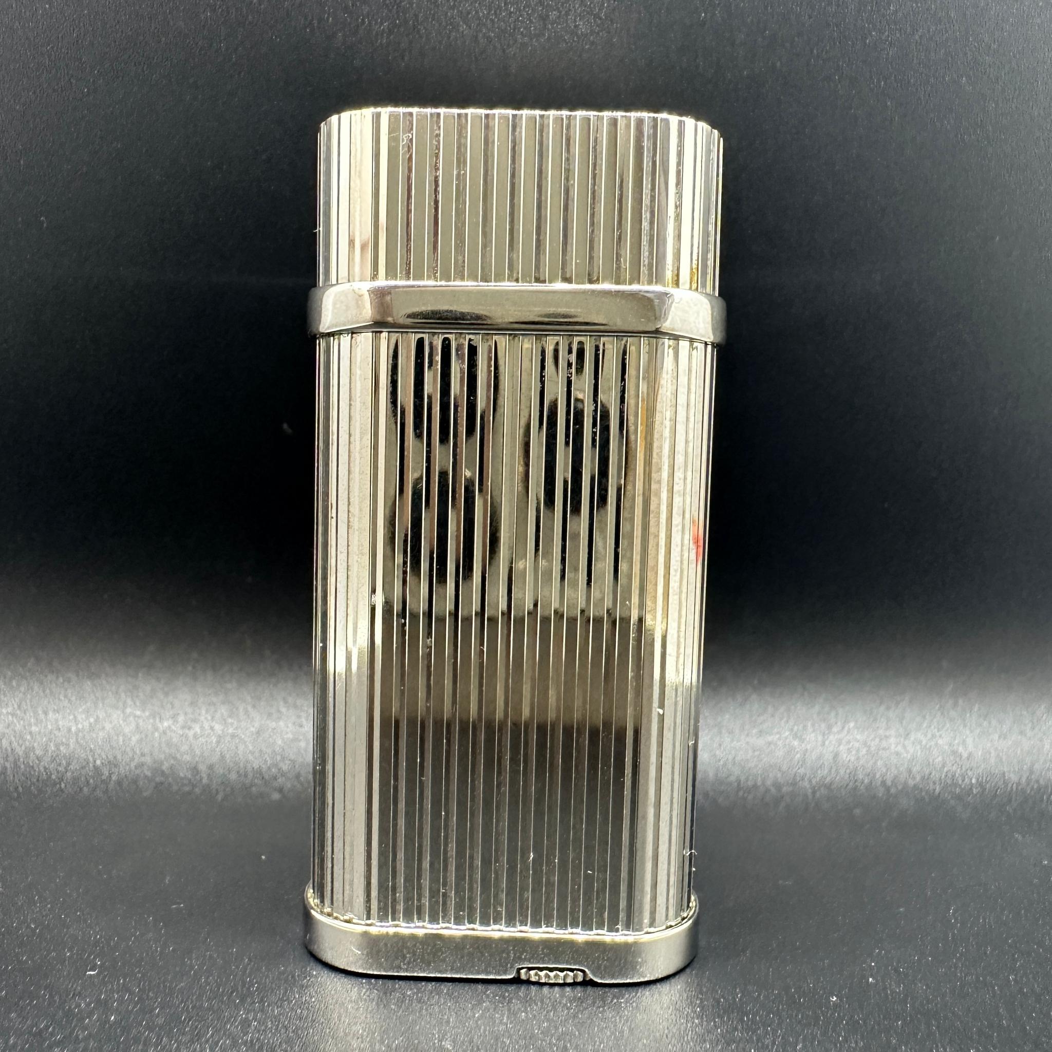 Cartier lighter 
Silver Cartier Gas Lighter Platinum finish
In Mint condition
Comes in original Cartier box 
With original Cartier papers 
The lighter is compact and beautiful and works perfectly. 
Collectable
