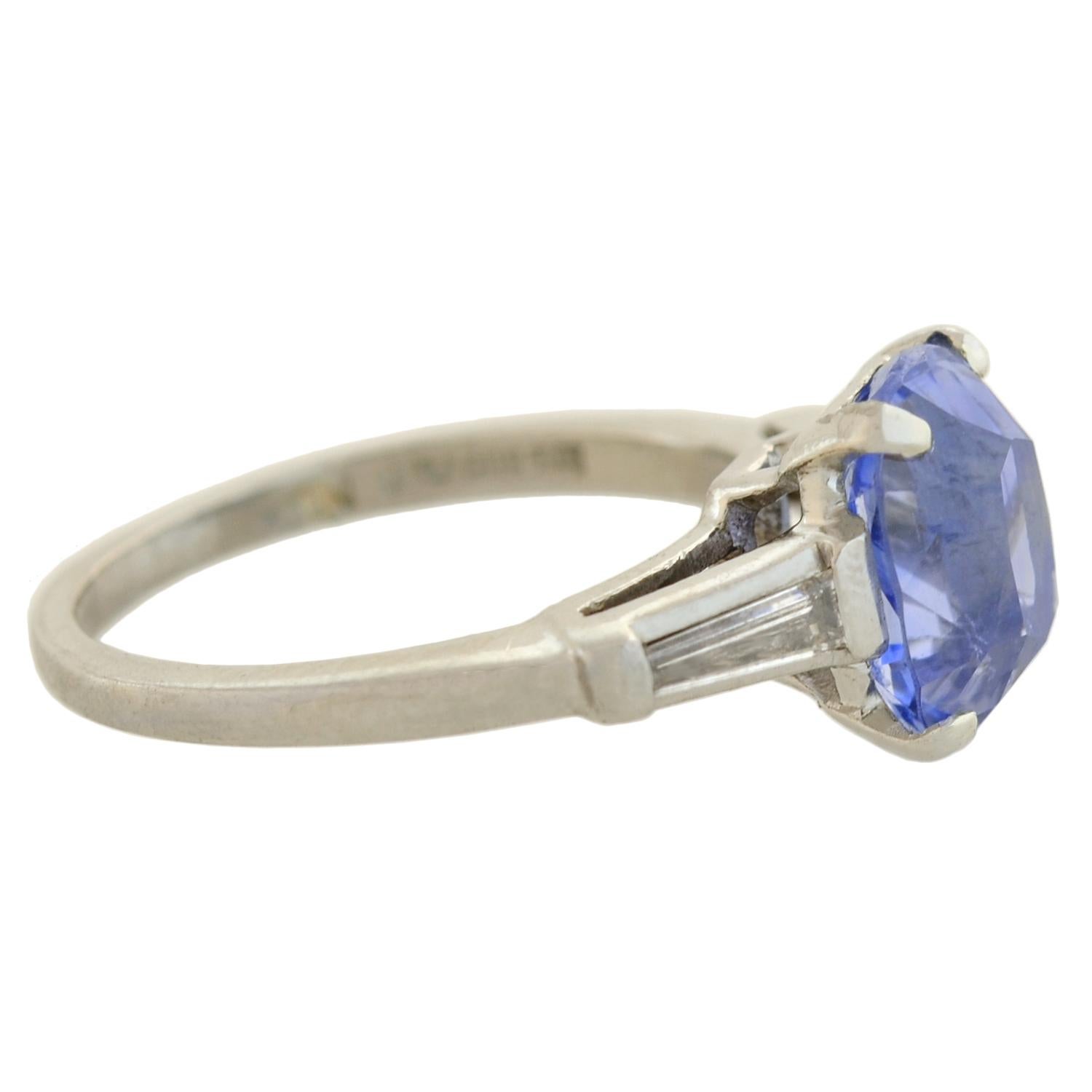 An exquisite sapphire ring from the Retro (ca1940s) era! Crafted in platinum, this fantastic piece holds a stunning natural sapphire at the center, framed by sparkling diamonds at either shoulder. The Ceylon (Sri Lankan) sapphire has an exact weight