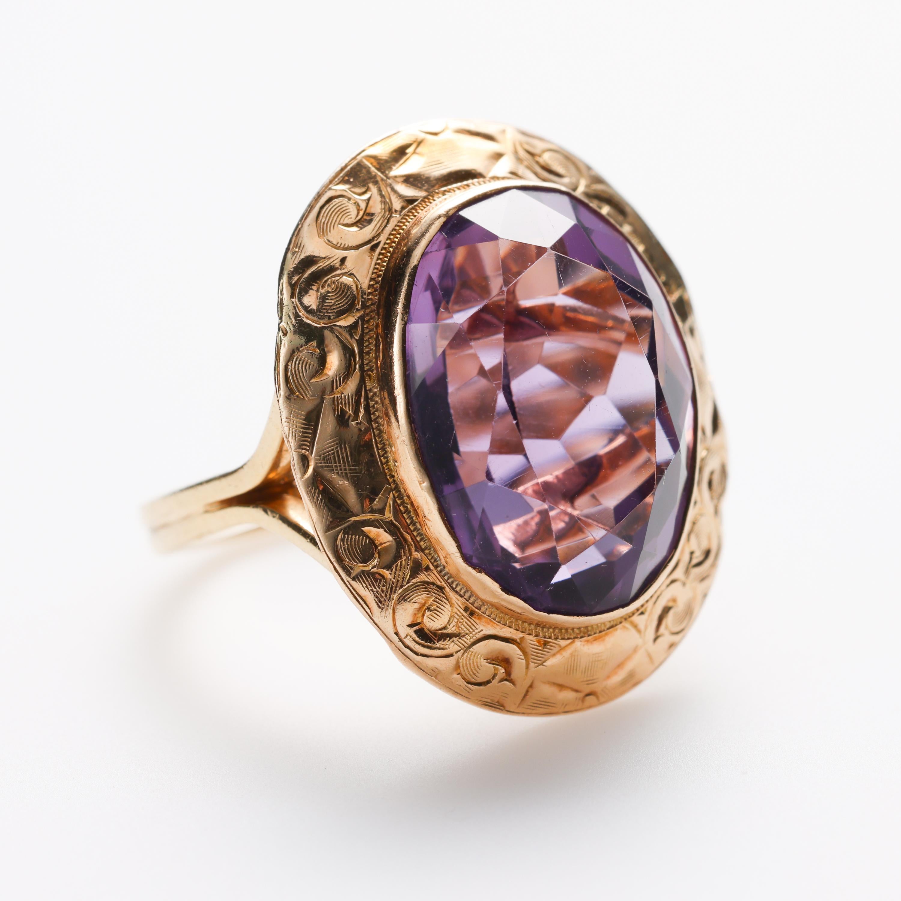 Flashy and splashy, this 14K yellow gold hand-fabricated ring features a large (Approximately 7.5 carats) natural, fire-filled amethyst. The stone is beautifully cut and bezel-set. The ring measures 22.43mm north to south and 18.43 west to east. Yet